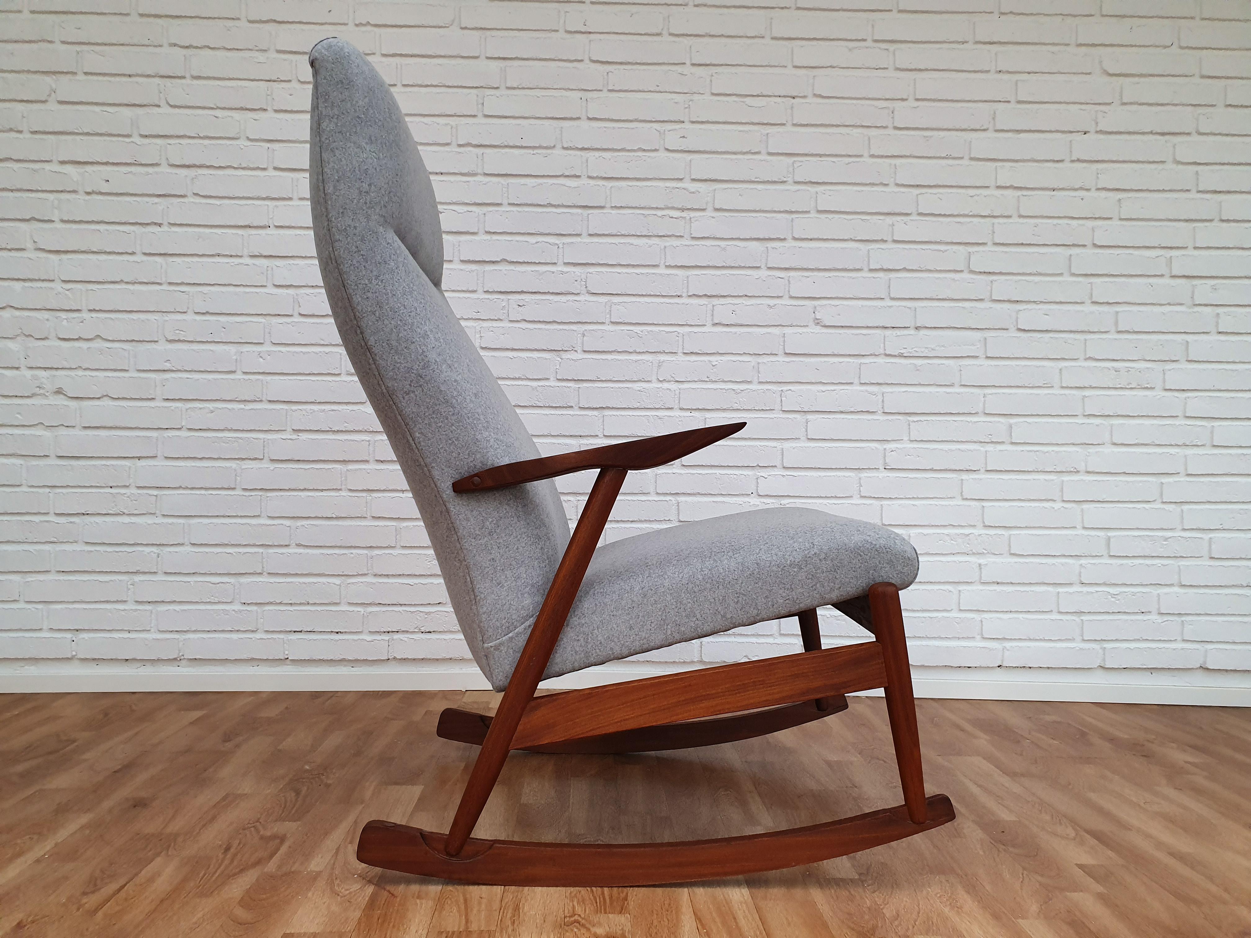 Rocking chair with teak frame. Made in circa 1960. Total renovated in quality gray wool fabric by furniture craftsman at Retro Møbler Galleri. Brand new padding with natural coconut mat. The frame is renewed, in very good condition.