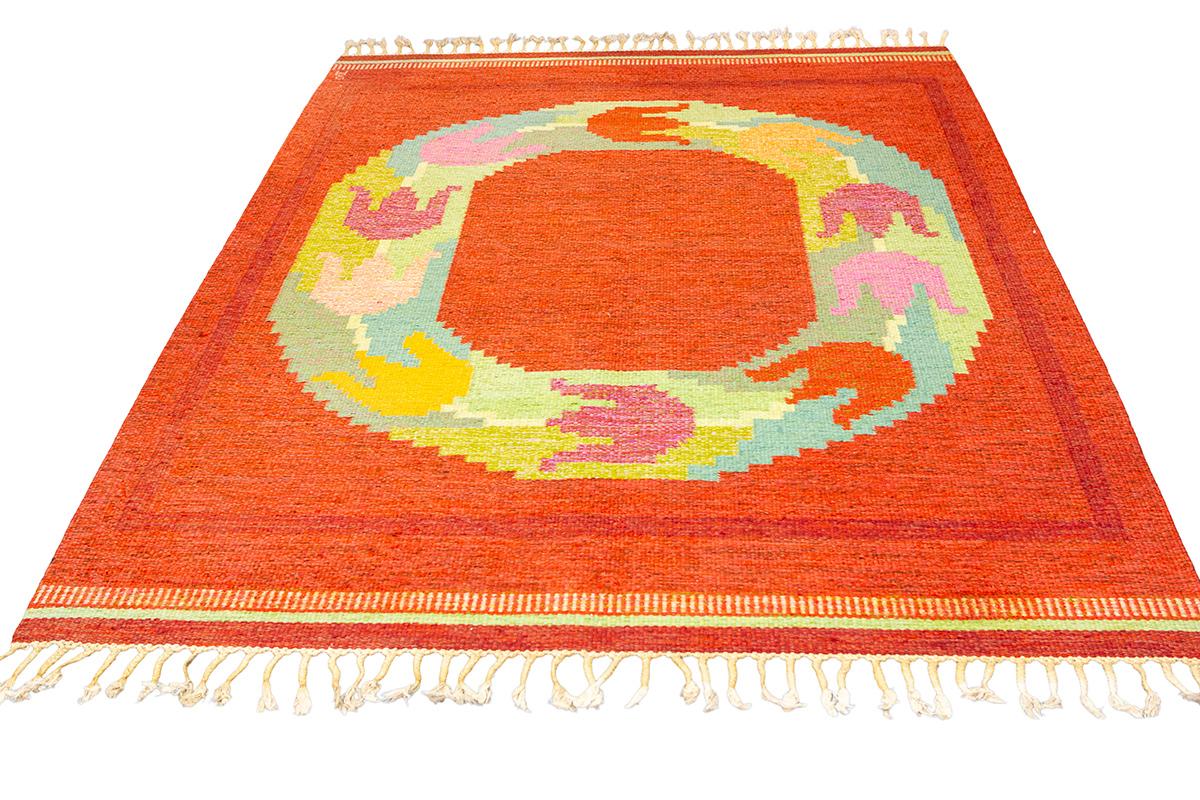 Immerse yourself in the vibrant world of Scandinavian Rug Rollakan with this eye-catching Scandinavian Rollakan rug, which features a bold and spirited play of colors and forms. This piece is a standout example of how traditional Scandinavian