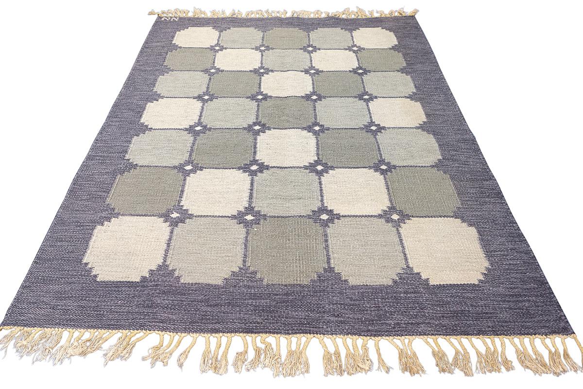 Embrace the beauty of Scandinavian design with this stunning Scandinavian Rug Rollakan, signed with the initials NN, a notable testament to its designer's skill and vision. This flat-weave rug, with its understated elegance and impeccable geometric