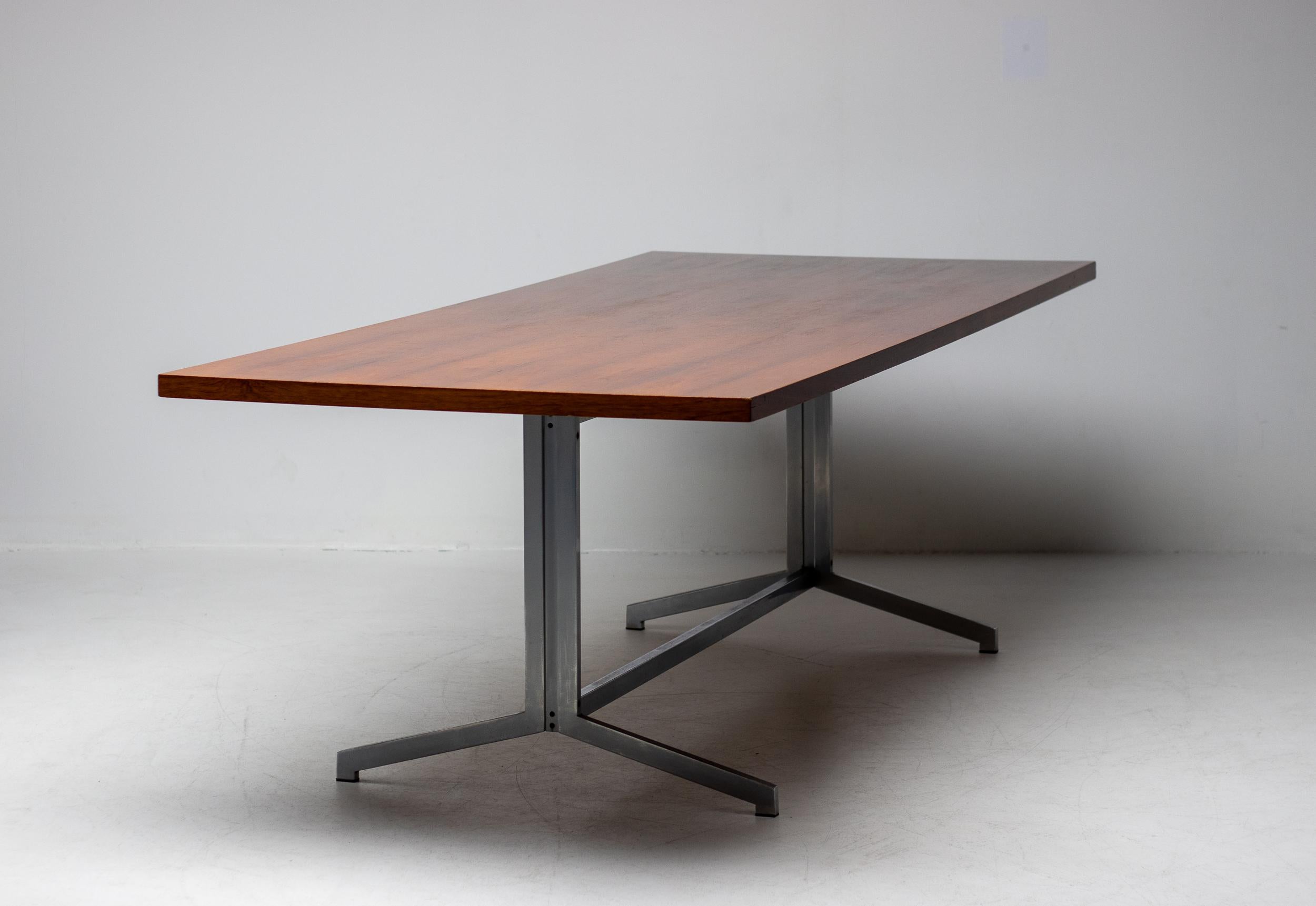 Large Mid-Century Modern stainless steel table with a beautiful rosewood top.
Good vintage condition with many superficial scratches on the top but no veneer damage.
Could be refinished to perfection but we prefer this original patina.
 