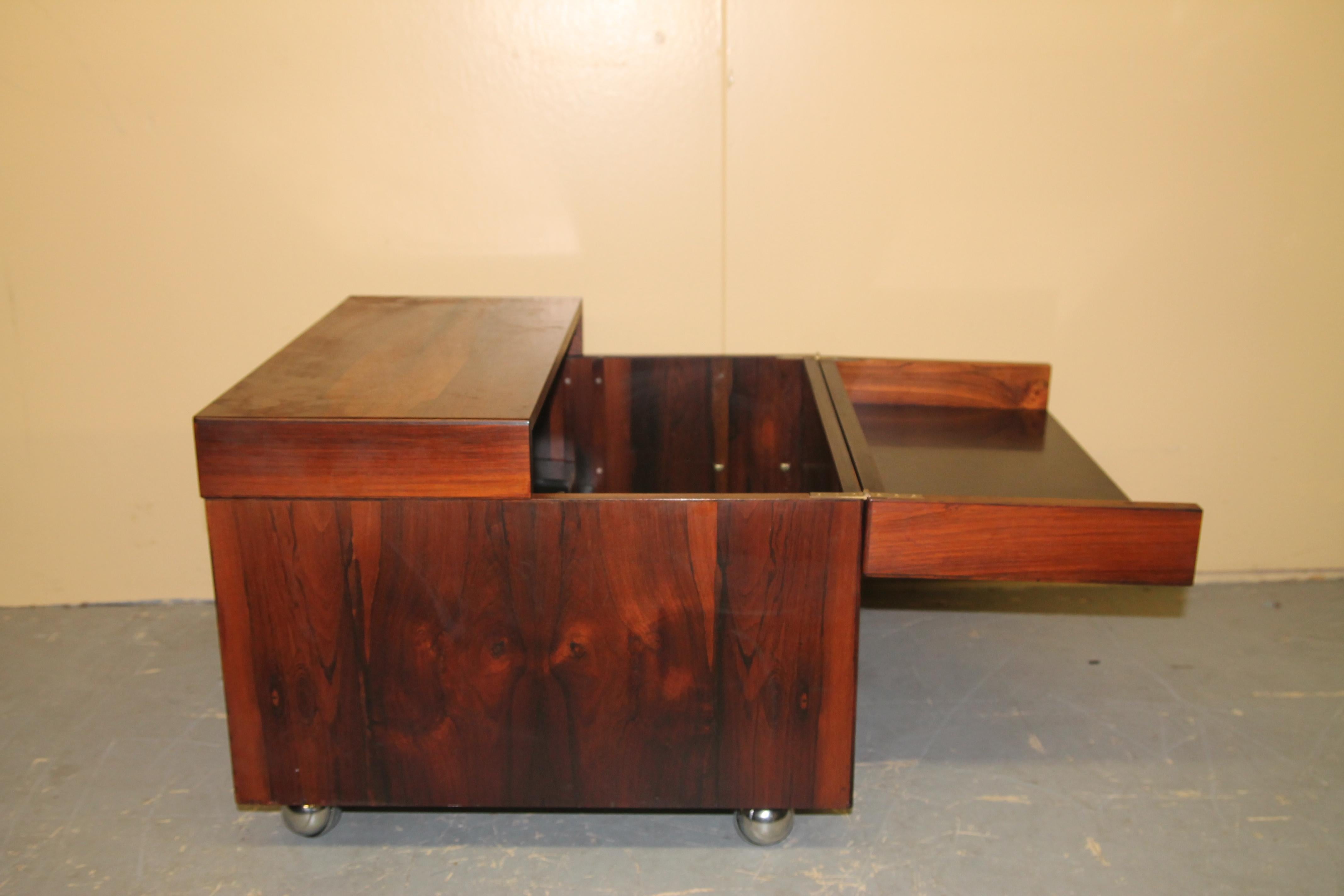 Rosewood cube bar. This serves as both a bar and coffee table. Bar is on wheels and when opened give you ample storage for items inside as well as a place to sit drinks and bottles. In nice vintage shape.