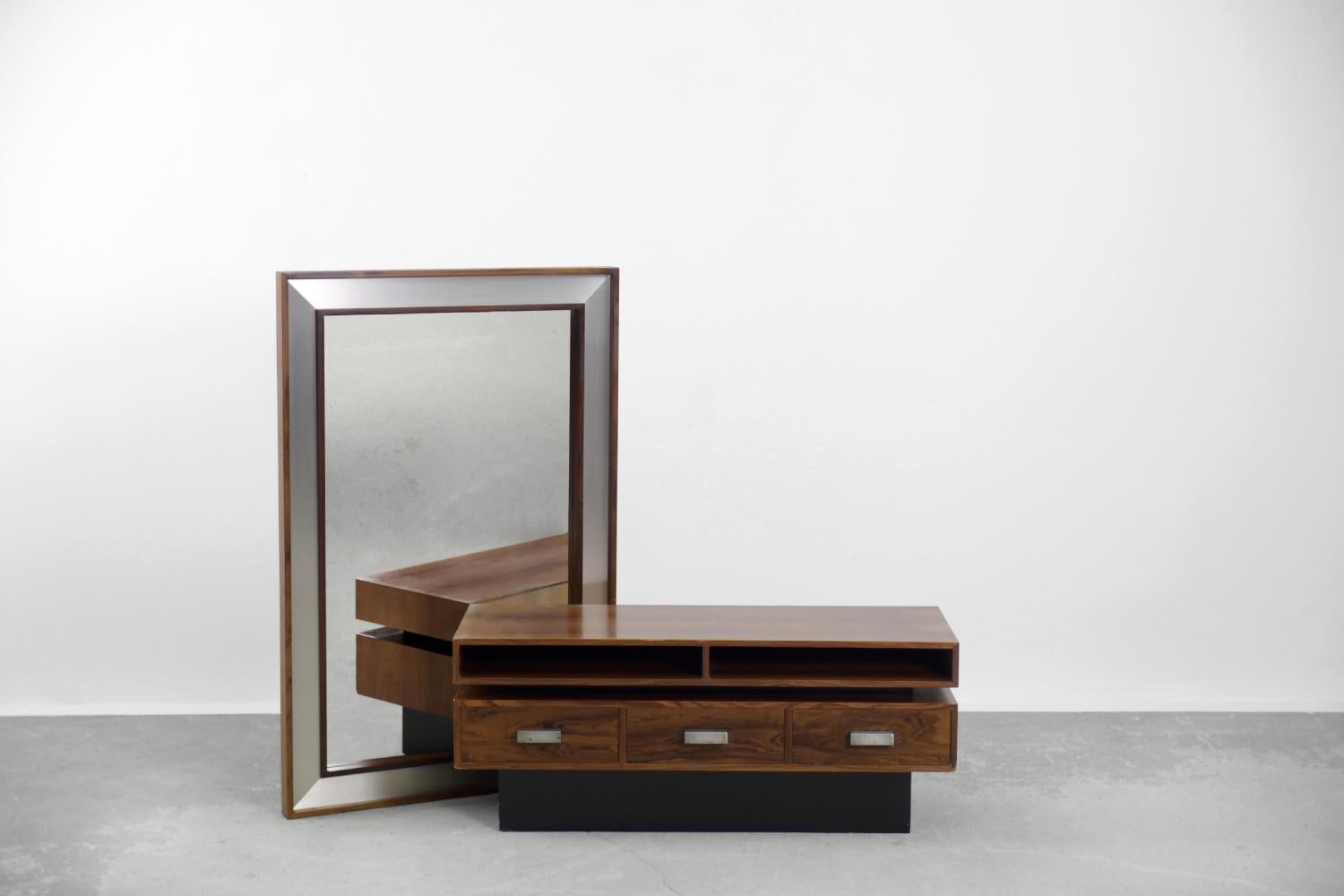 This modernist dressing table with a mirror was manufactured in Sweden during the 70s. The console was finished with dark rosewood with very strong structure and distinctive graining. It makes this piece look very decorative and luxurious. The piece