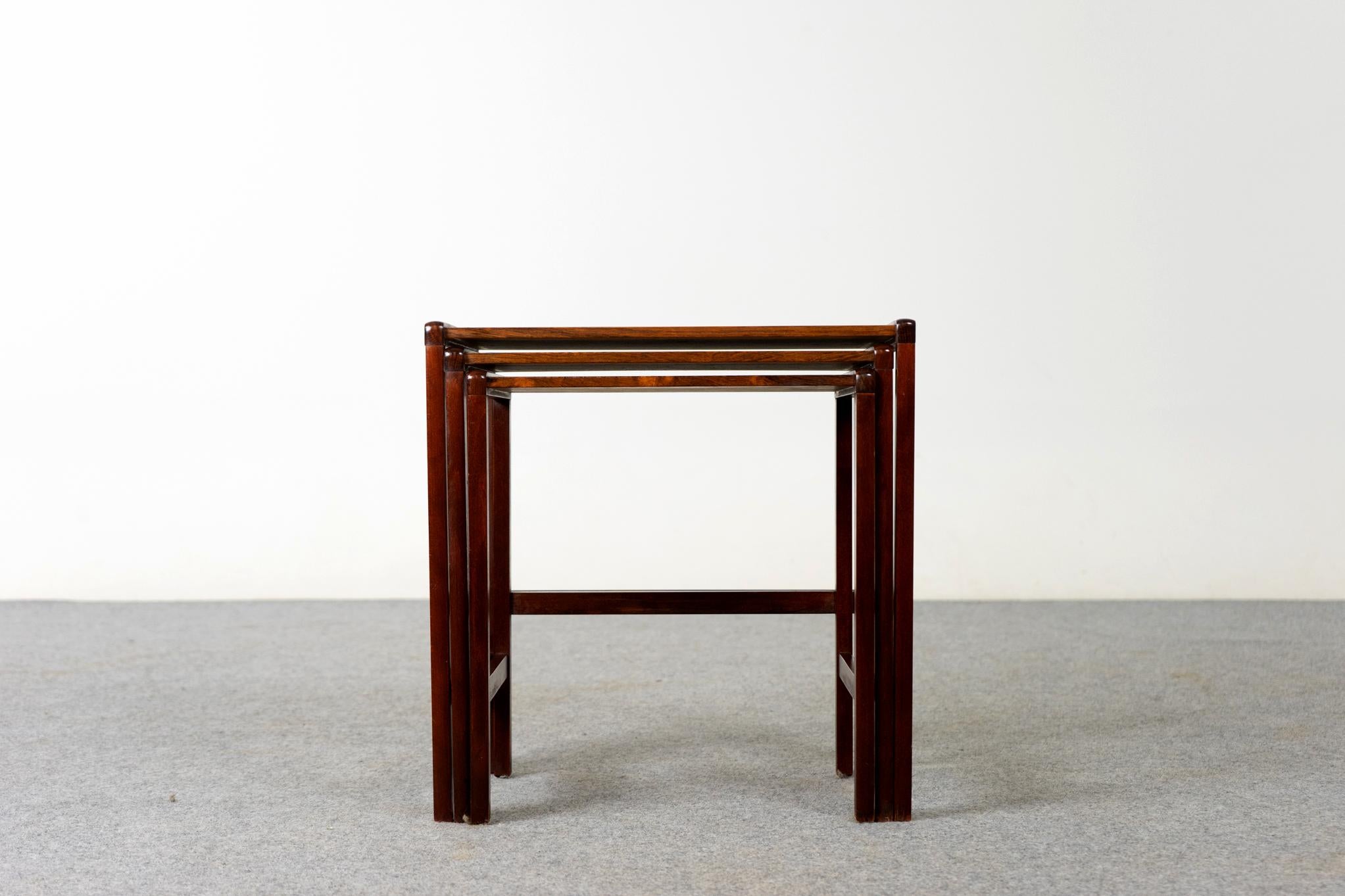 Rosewood Scandinavian nesting tables, circa 1970's. Use them individually or nest them together to save space. Book matched veneer and solid wood trim make these an elegant addition to any living room. Make the most of the space have with these