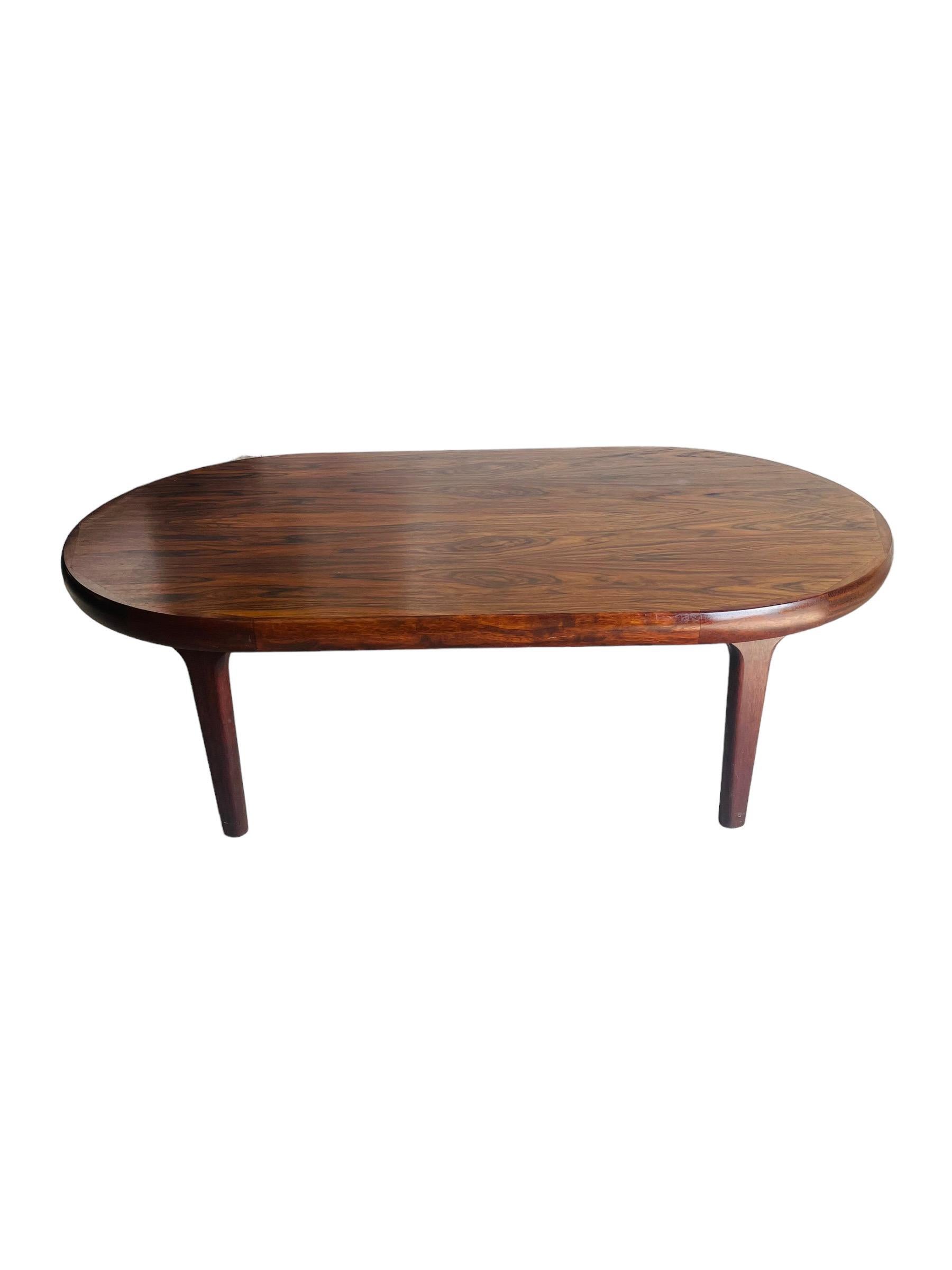 Introducing our stunning Scandinavian Rosewood Oval Coffee Table with Curved Edges - the perfect centerpiece for any modern home. This sleek and stylish table boasts a beautifully crafted oval-shaped top made of high-quality rosewood, providing