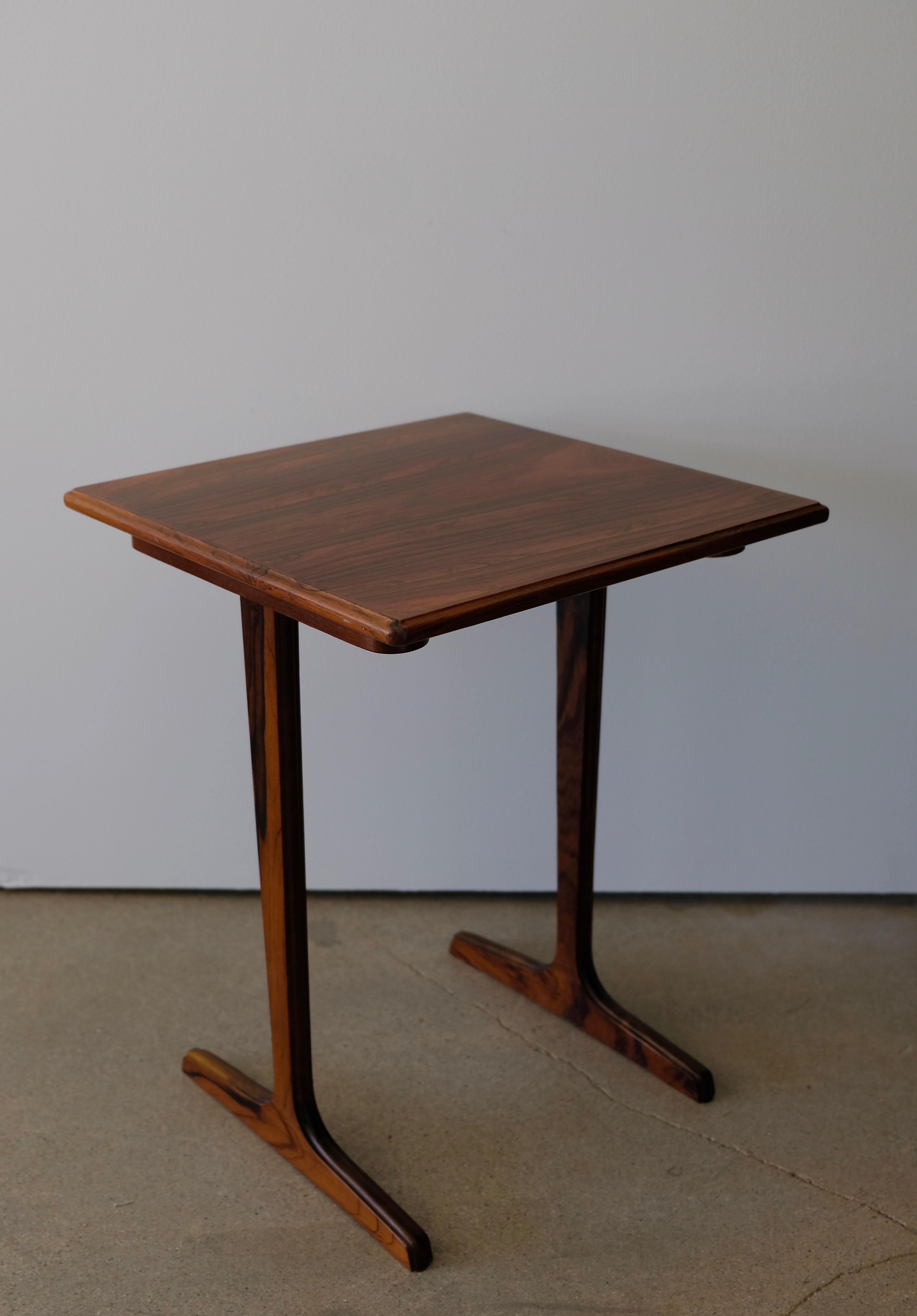 A chic little side table made of beautifully grained rosewood.
It is light but sturdy and would work well between two lounge chairs or at the side of a sofa.
 