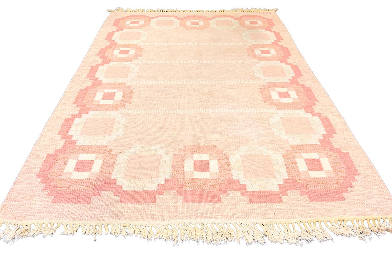 This is a Scandinavian Rollakan Swedish Signed GG is an exquisite and distinctive piece that radiates uniqueness and elegance. With its geometric design and soft shades of pink, this Rollakan stands out as a truly special textile. The delicate hues,
