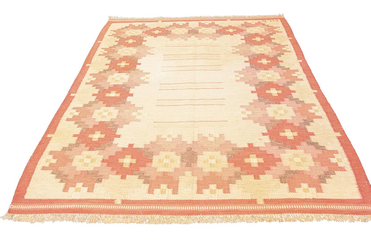 Scandinavian Rollakan Rug Signed MLB  Warm Floral Geometrics
This charming Scandinavian Rollakan rug, signed MLB, showcases a beautiful geometric floral design around an open, minimalist center. Woven with an elegant palette of soft beige, warm