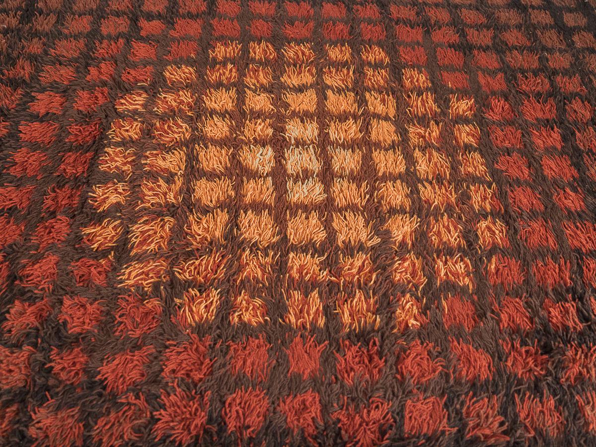 Rectangular Rya rug designed by Verner Panton for Danish textile company Unika Vaev. Rug is in very good overall condition and features warm, gradated earth tones in a radial pattern. Denmark 1960s.
