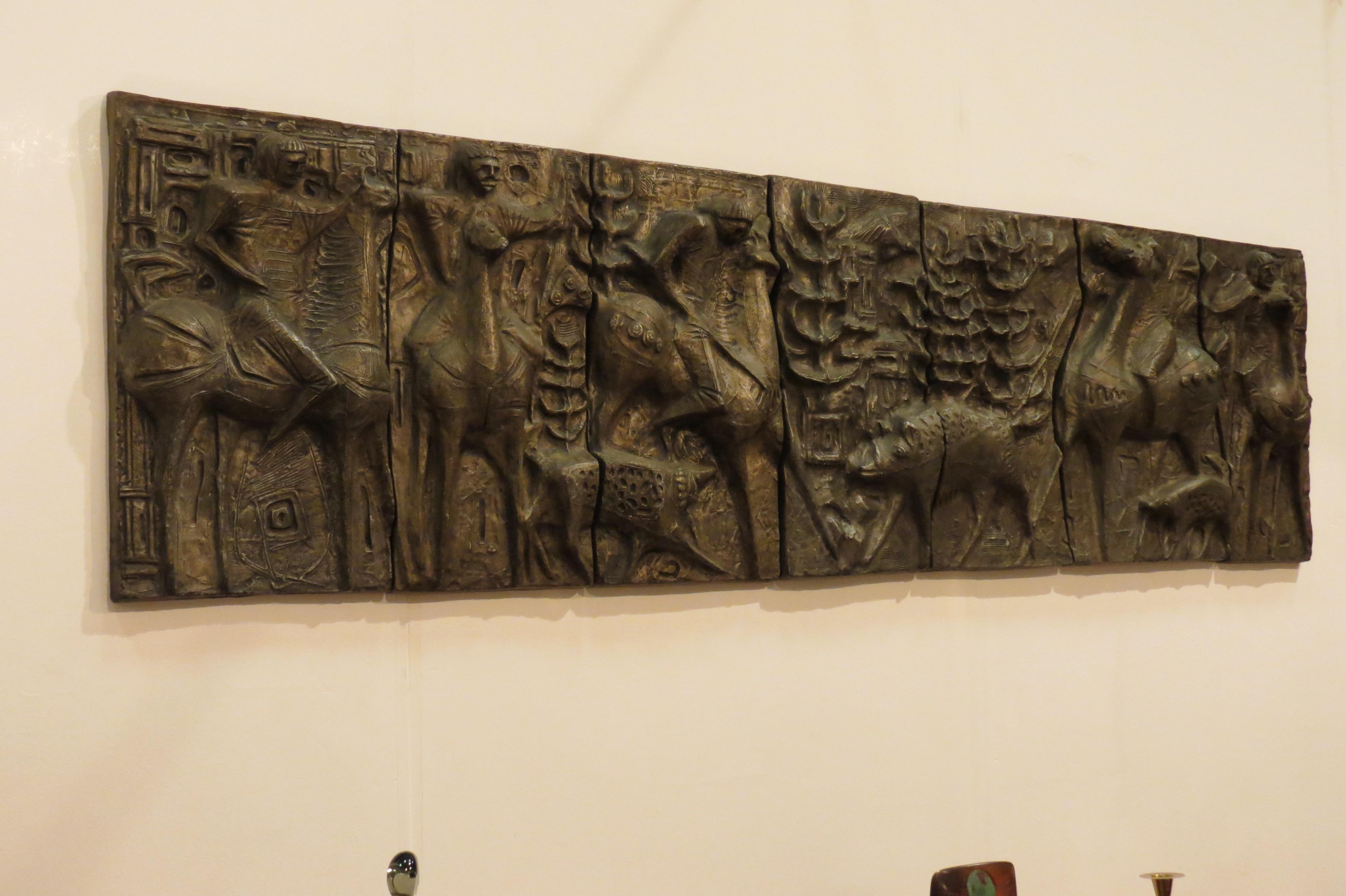 A unique wall hanging of a boar hunting scene dating from the 1960s. 

The scene consists of seven individual panels that sit alongside each other to form an impressive, sculptural piece of wall art.

Made from cast resin allowing it to be hung