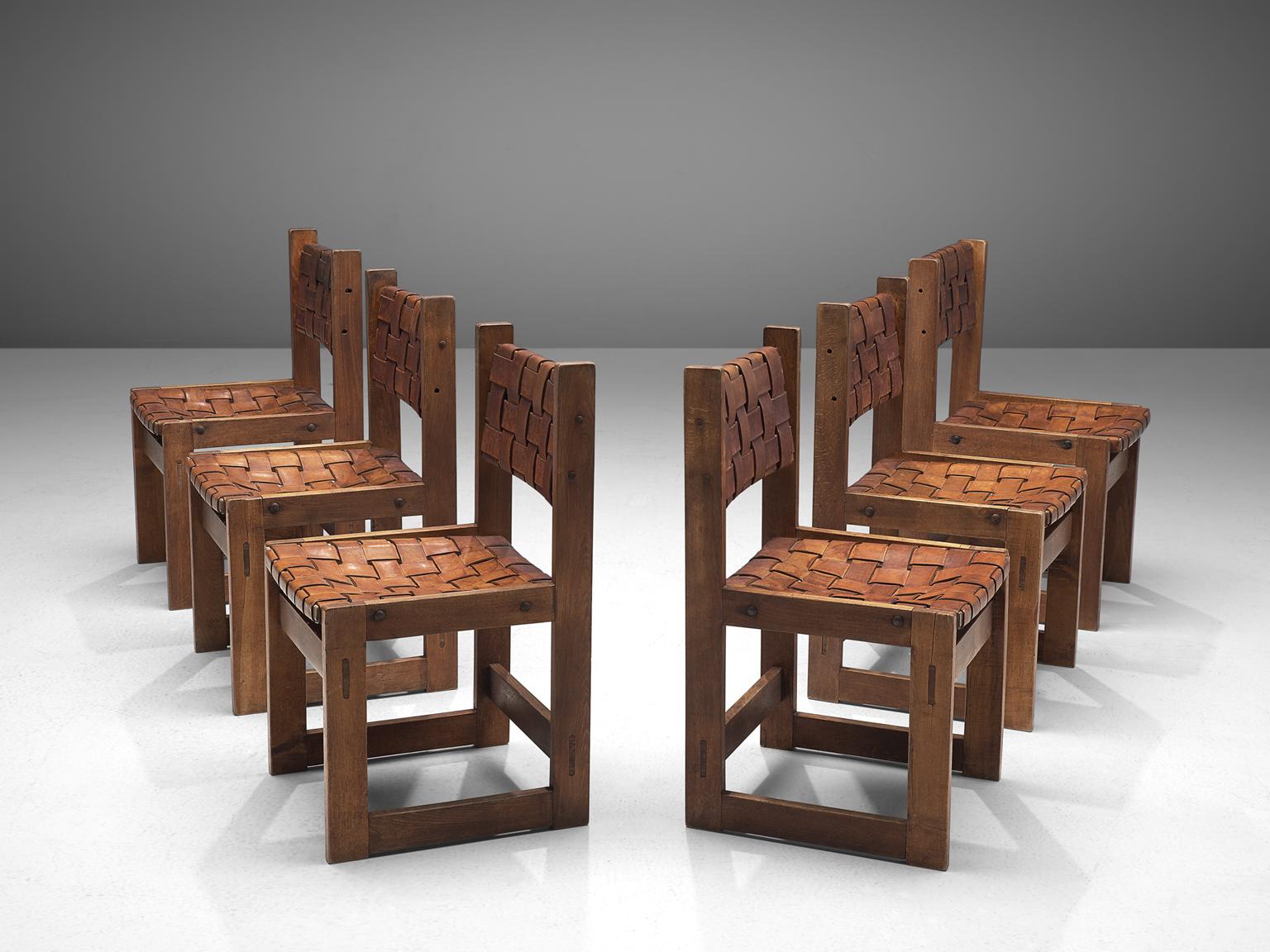 Set of 6 dining chairs, elmwood and patinated leather, Scandinavia, 1922.

A set of midcentury dining chairs in thick saddle leather. The woven seats and backrests consist of cognac leather straps that aged beautifully, resulting in an admirable