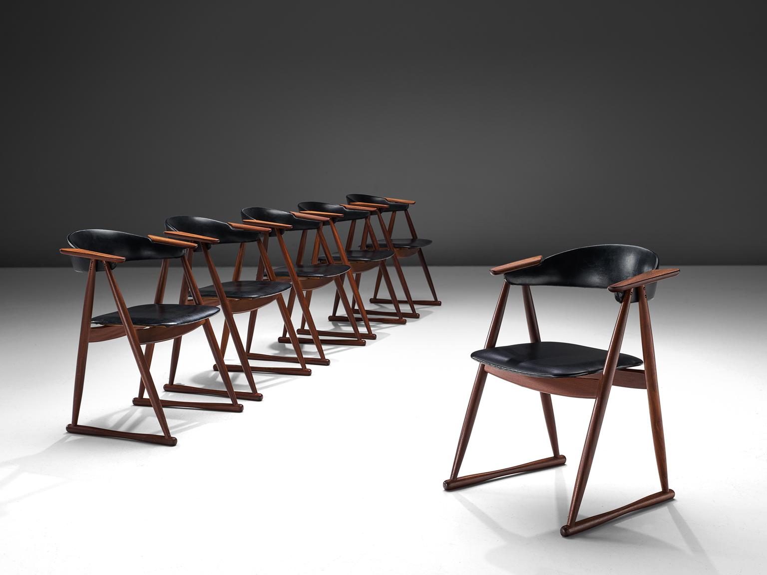 Set of six dining chairs, black faux leather and teak, Denmark, 1960s.

This set of dining chairs are made by cabinet maker Randers Møbelværk in the 1960s. The playful design features protruded armrests that lean on triangular shaped frame. At the