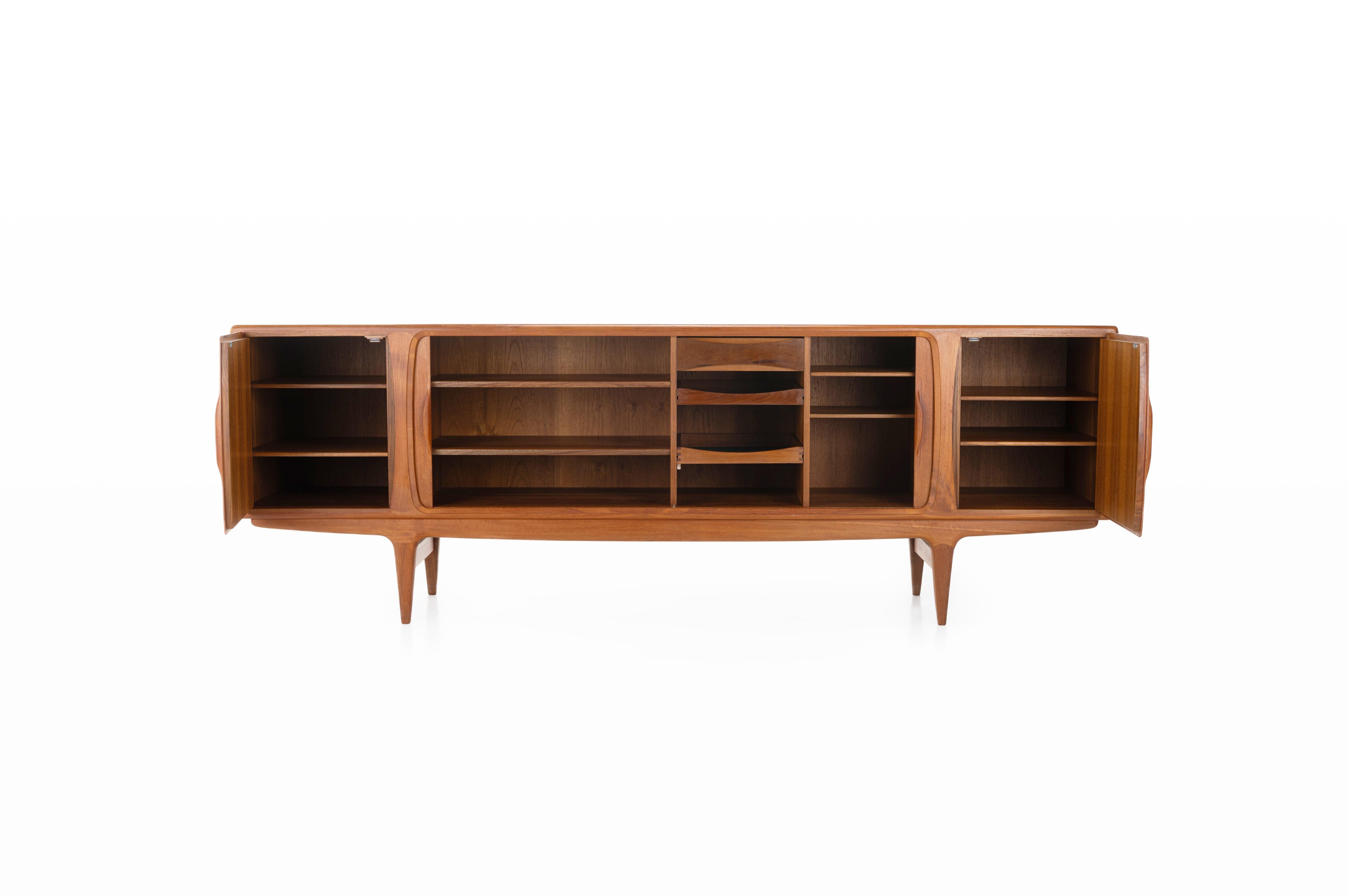 Magnificent sideboard in teak designed by Johannes Andersen for Uldum Møbelfabrik, Denmark 1960s. This sideboard has four tambour doors, two doors and plenty of storage space.

Dimensions:
W: 245 cm
D: 52 cm
H: 83,5 cm