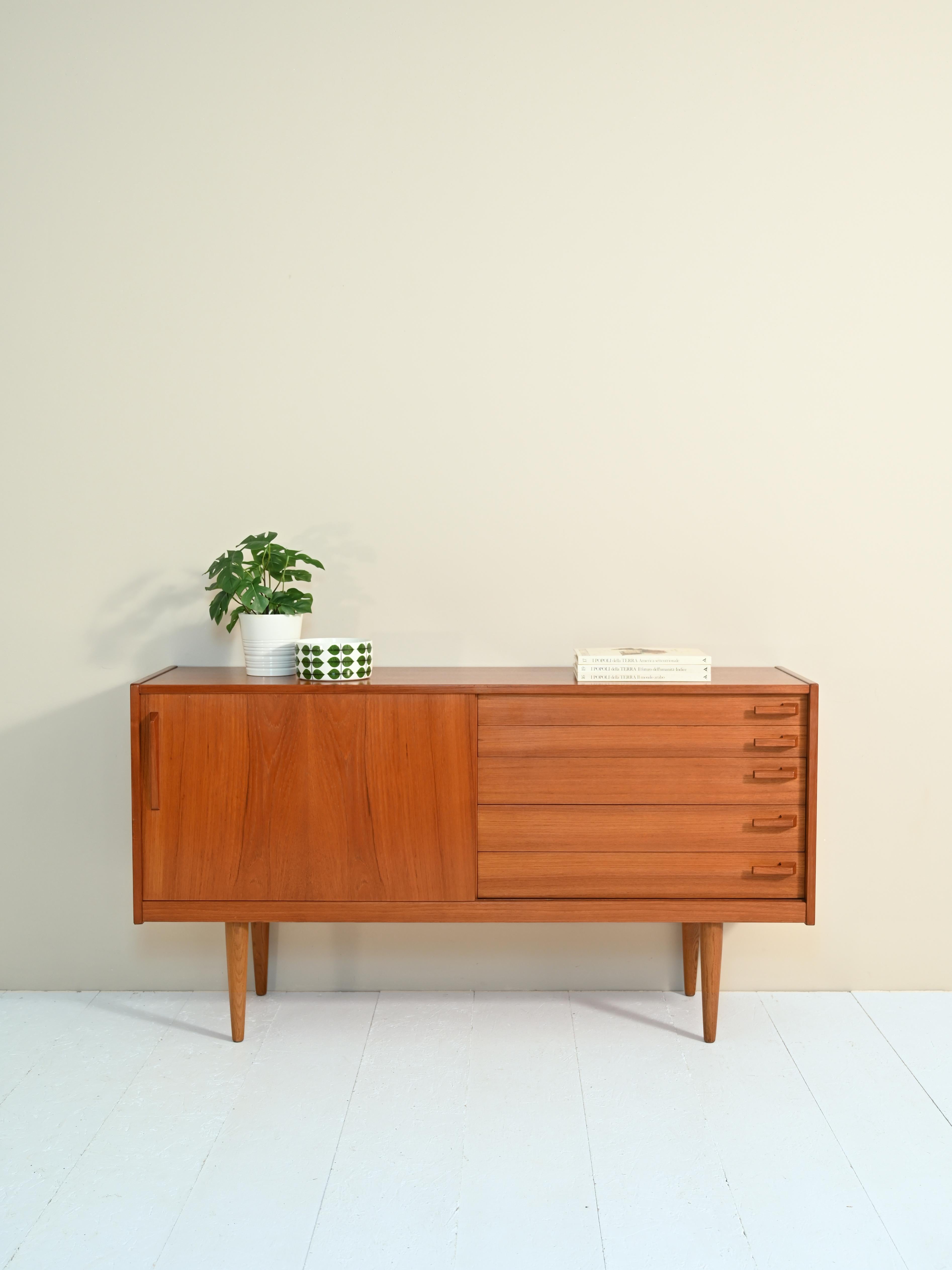 Scandinavian sideboard by designer Yngve Ekström produced at the turn of the 1950s-60s in Sweden.

The vintage sideboard features a sliding door on the right side and five drawers on the left side.

The characteristic elements of this sideboard