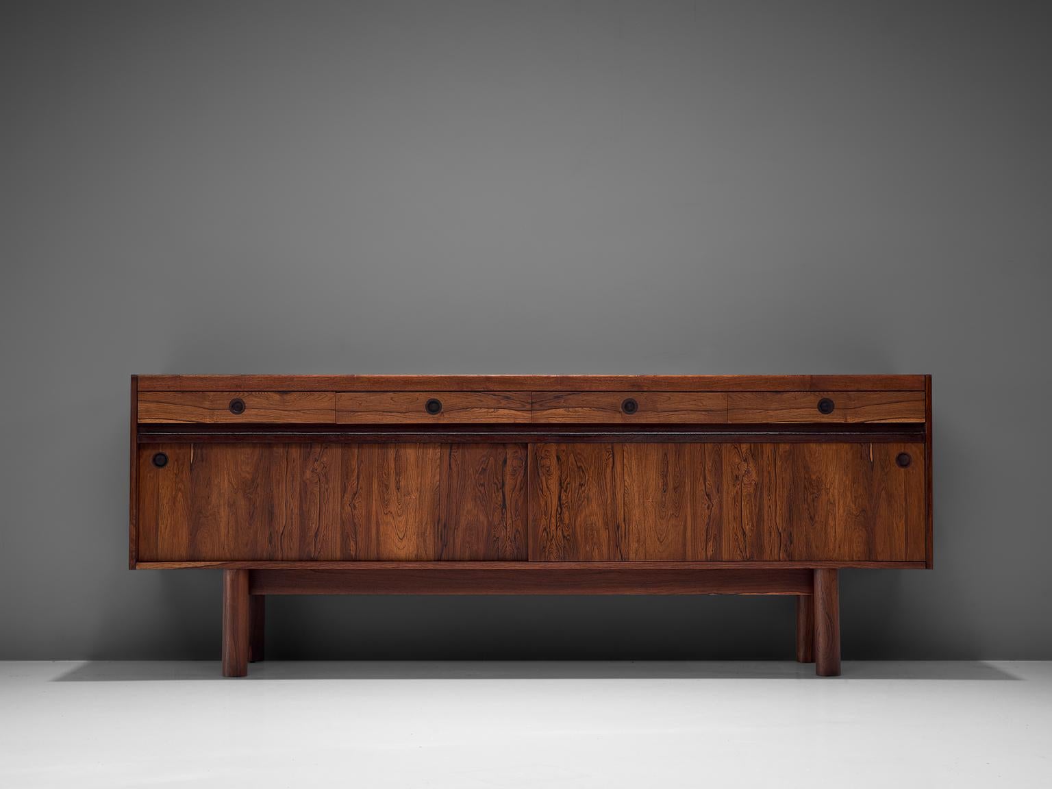 Sideboard, rosewood, Scandinavia, 1960s

This Scandinavian credenza is executed in rosewood. It consist of two sliding doors with characteristic black round inlayed handles, and four drawers. The design of this model is simplistic, with attention