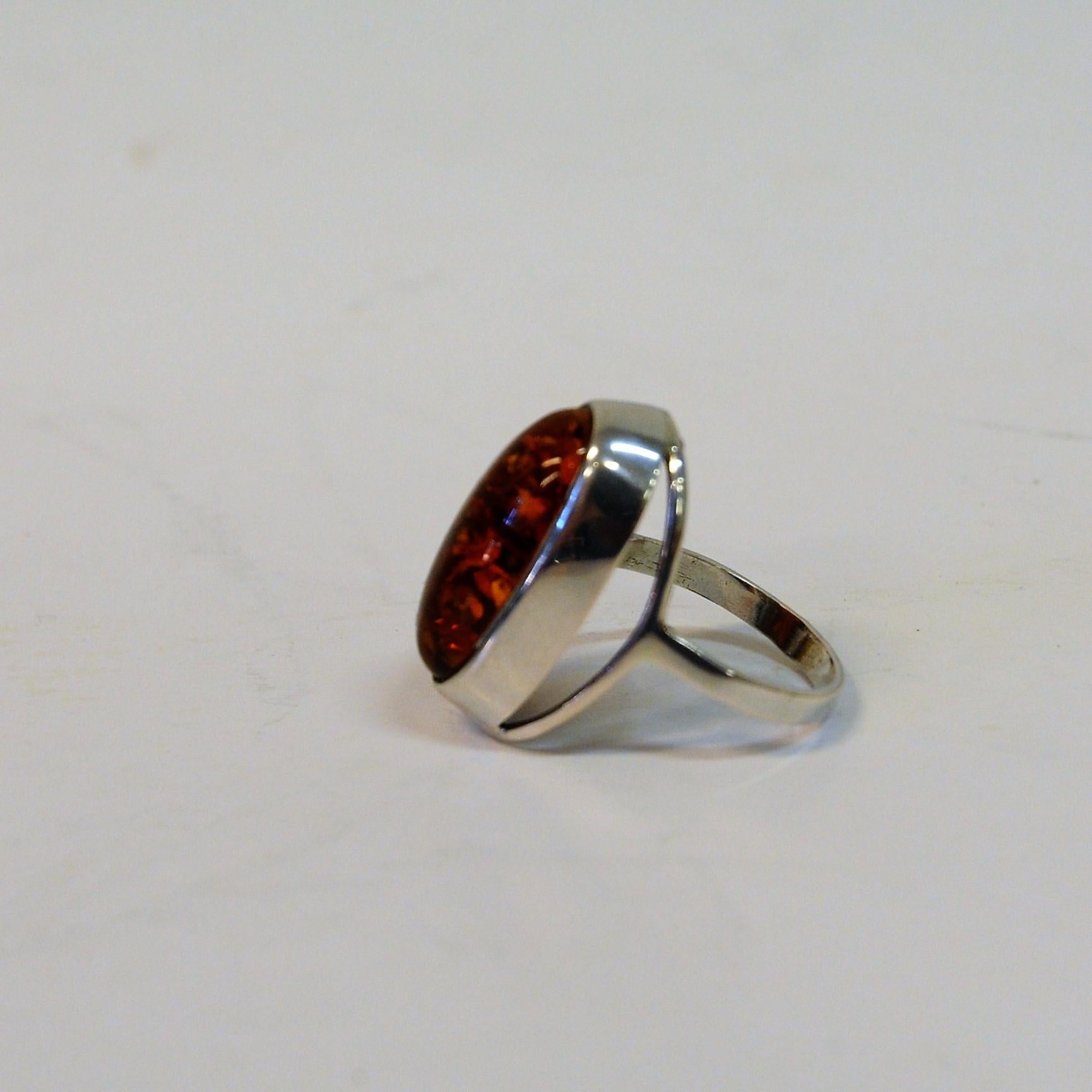 Attractive sterling silver ring with a big beautiful amber stone from the last midcentury (1960s) Denmark. (Nakskov, 1944-2009). Stamped. Sterling, Denmark, 925S & N. E. From. Size 52 mm. Perfect vintage condition.
 