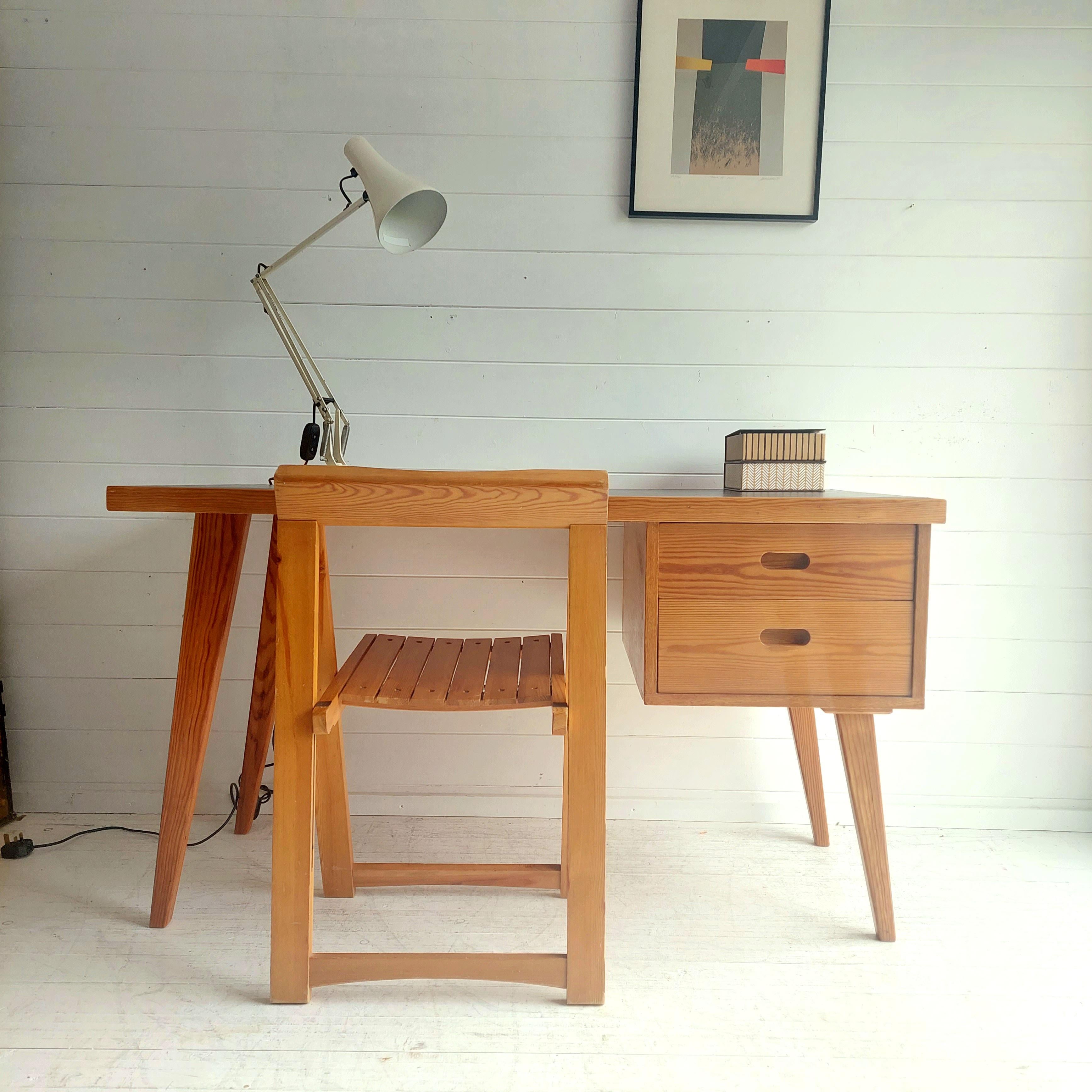 Mid Century  Paul McCobb/Baumann style office desk of the 1960s.
Vintage Scandinavian Design Writing Desk

Structure and compass legs in pitch pine 
Sides in beech wood. 
Black leatherette inserted top.
Single pedestal design:
Left side two conical