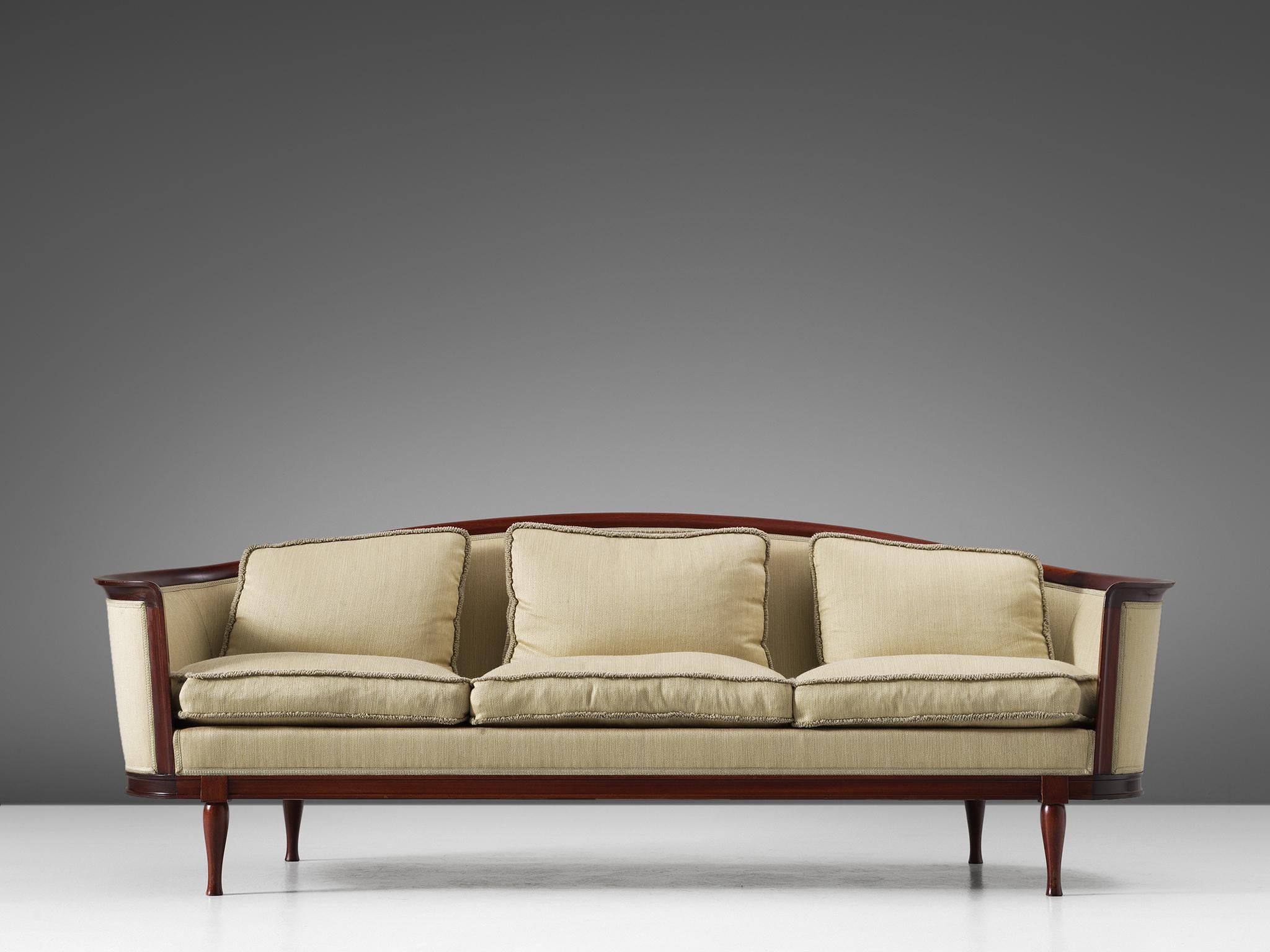 Sofa, in mahogany and fabric, Scandinavia, 1930s.

Luxurious Scandinavian sofa, with a variety of well designed lines and stunning details. Note the elegant curves that gives this sofa its characteristic look. Emphasized by the mahogany wooden frame