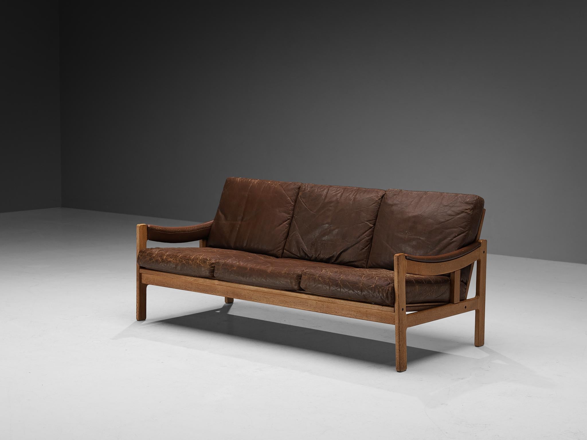 Sofa, oak, leather, Scandinavia, 1950s

This three-seater sofa beautifully reflects the stylistic traits of Scandinavian Modern Design. The base and backrest are pure and clear in their execution, giving the sofa both a simple yet stately