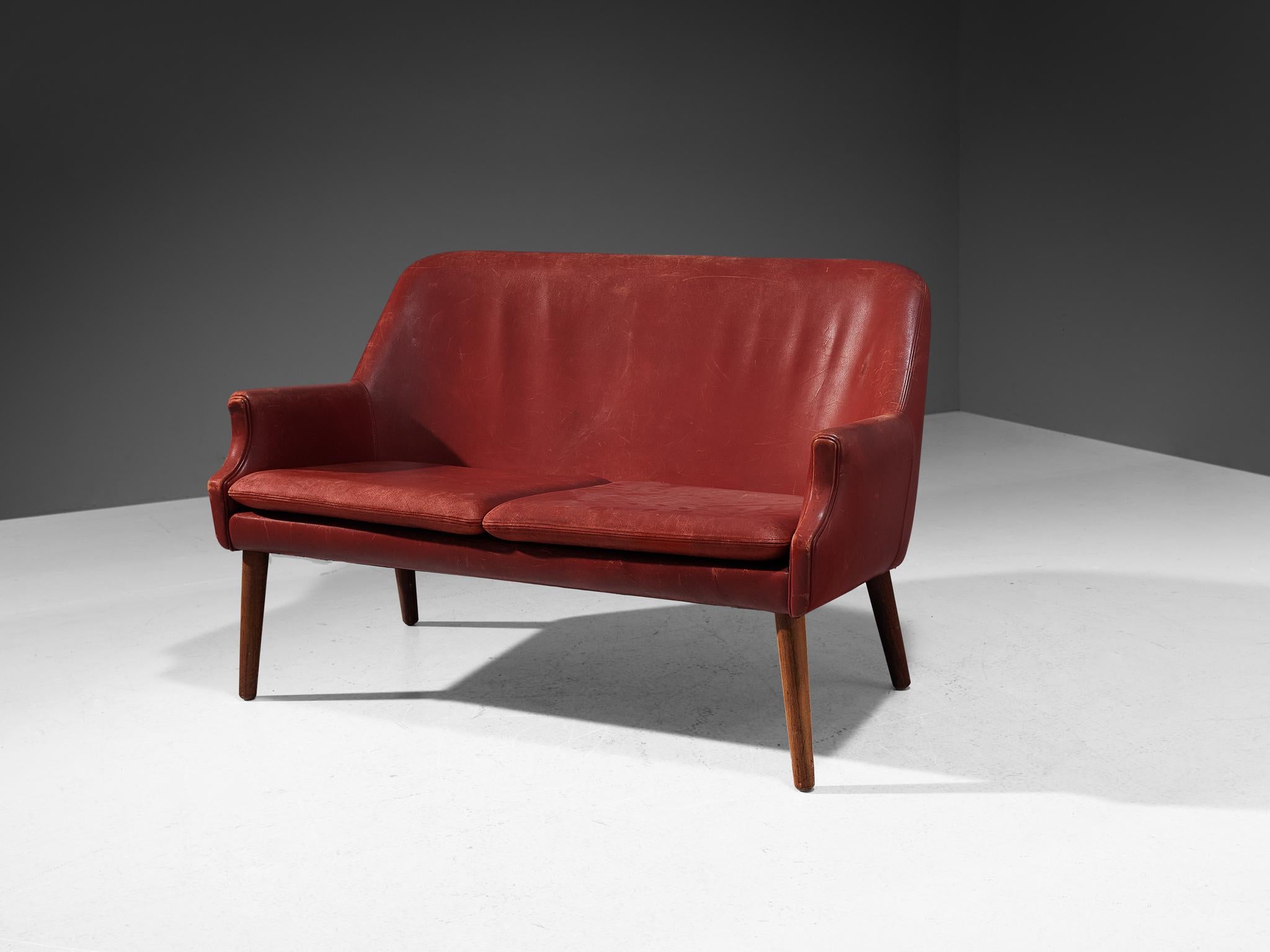 Sofa or settee, leather, wood, Scandinavia, 1950s

A beautifully sculpted sofa in the style of Danish designer Arne Vodder. The high back is slightly curved and runs smoothly over into the pointed armrests. The tapered wooden legs provide a nice