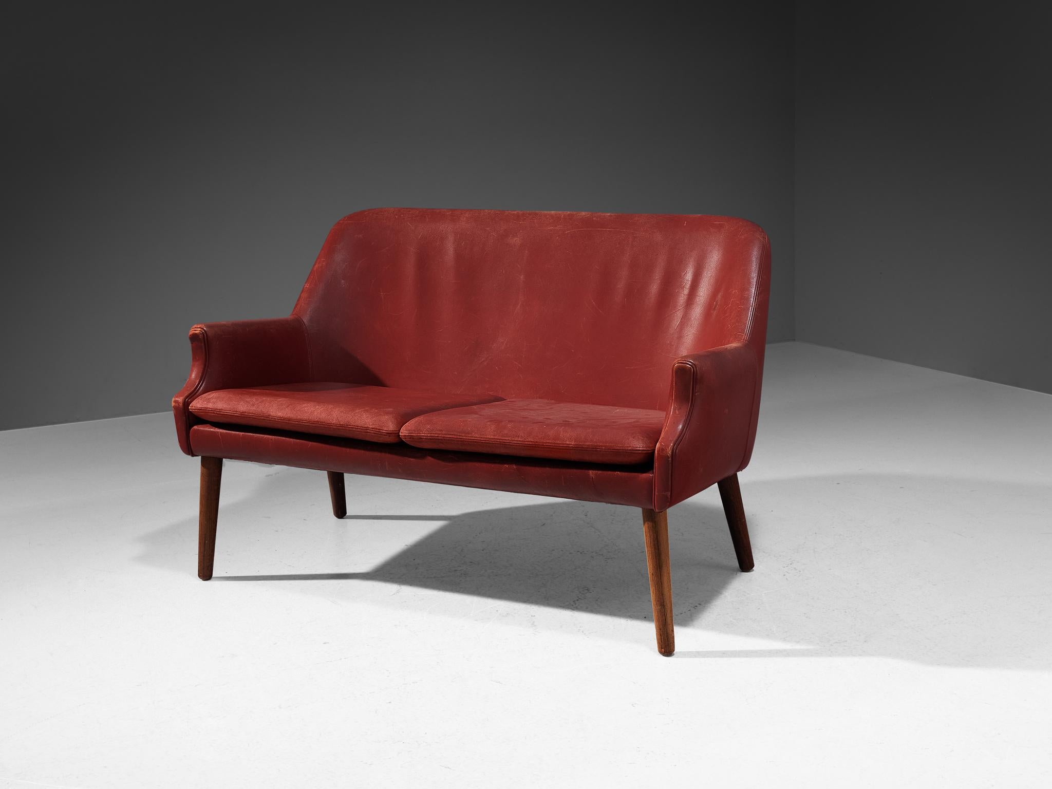 Sofa or settee, leather, wood, Scandinavia, 1950s

A beautifully sculpted sofa in the style of Danish designer Arne Vodder. The high back is slightly curved and runs smoothly over into the pointed armrests. The tapered wooden legs provide a nice