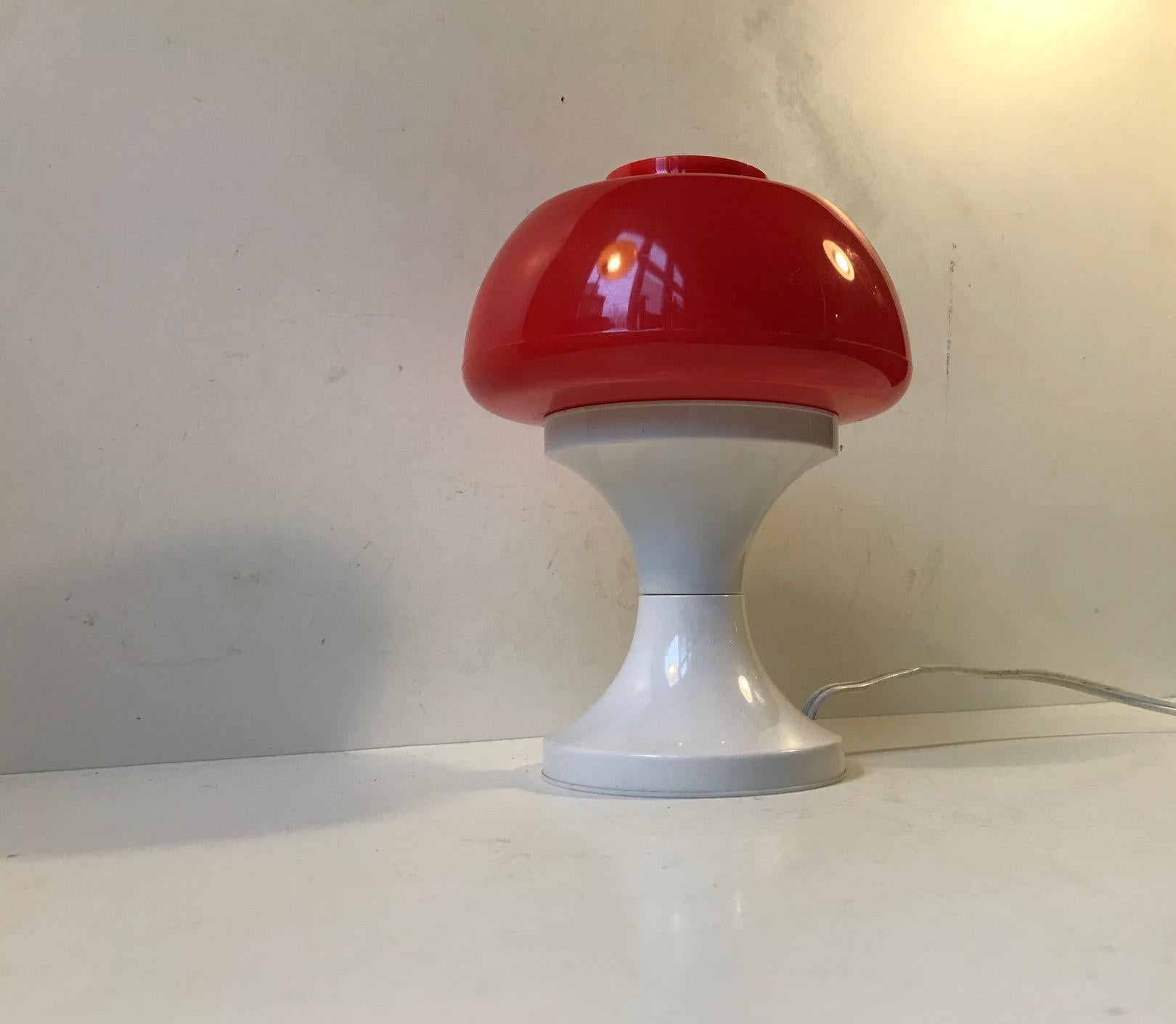 Small mushroom shaped table lamp made from shine through white and red acrylic. Manufactured by A. Schrøder in Denmark during the 1970s. Some believe its by Bent Karlby but it remains uncatalogued. This style of small table lights were popularized
