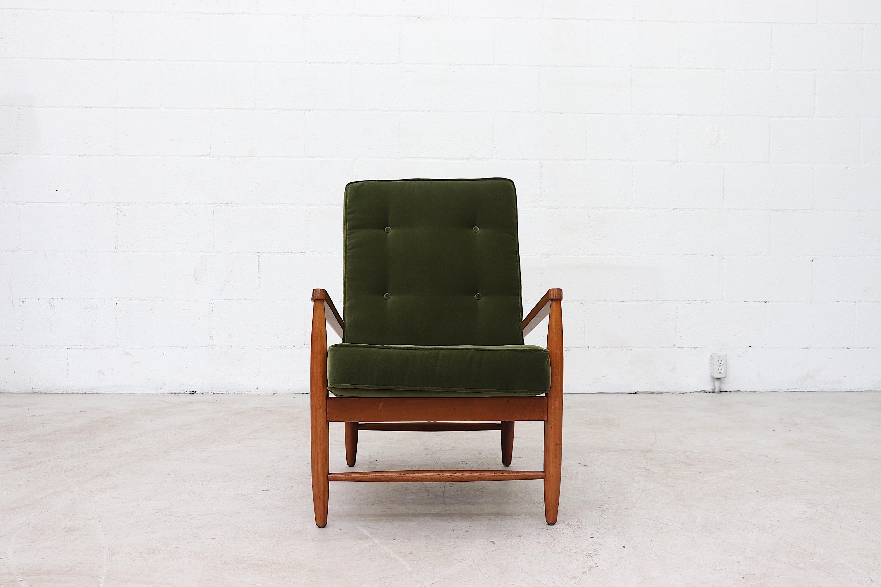 Modernist stick back lounge chair with olive velvet cushions and new seating straps on teak frame. Good original condition with wear consistent with age and use.