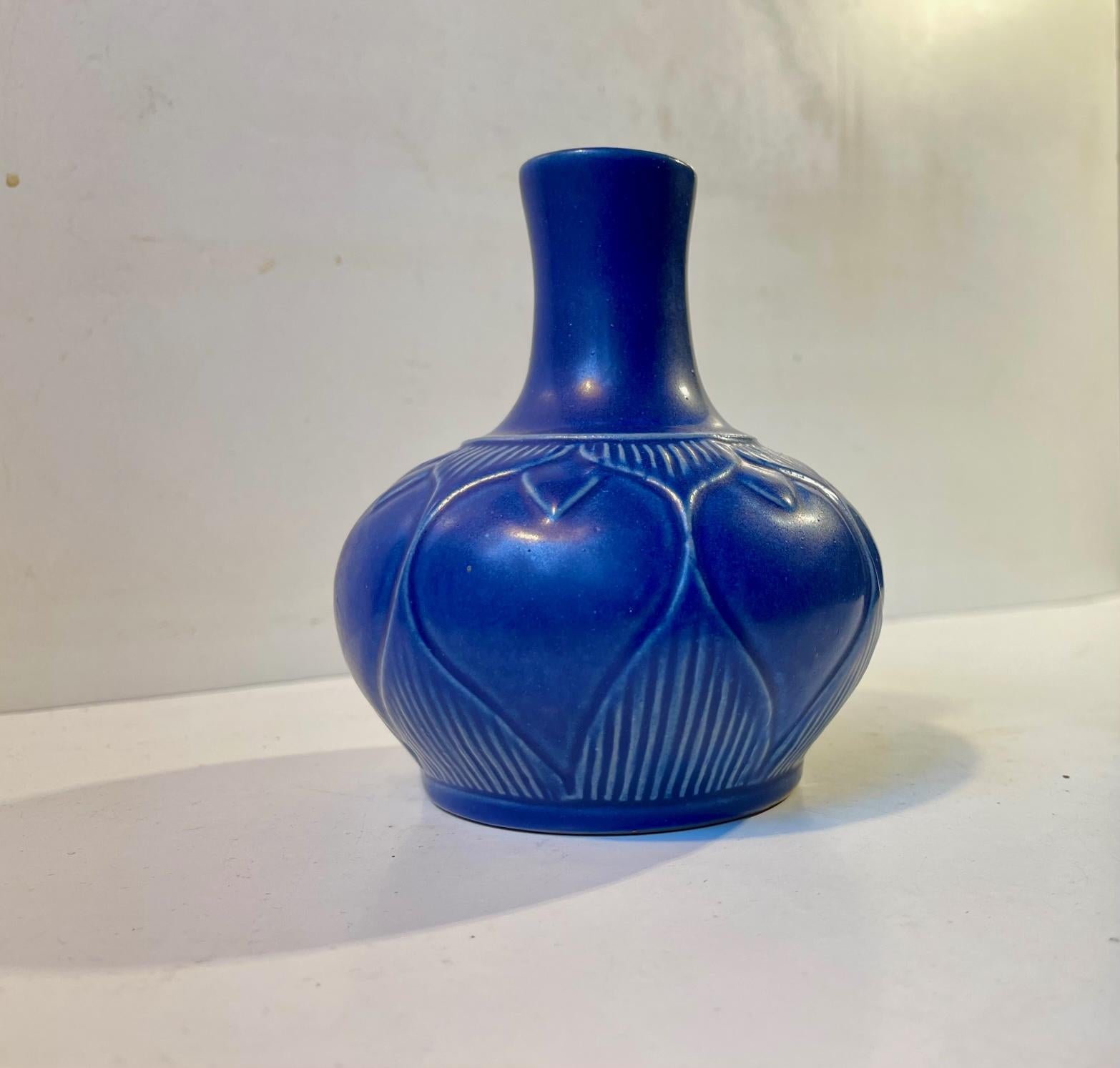 Among the most desirable pieces from L. Hjorth Ceramic in Denmark comes pieces by the Swedish Ceramist Eva Sjögren who worked with Hjorth for a period of time during the 1950s and 60s. This small vase with a delicate blue glaze and a highlighted