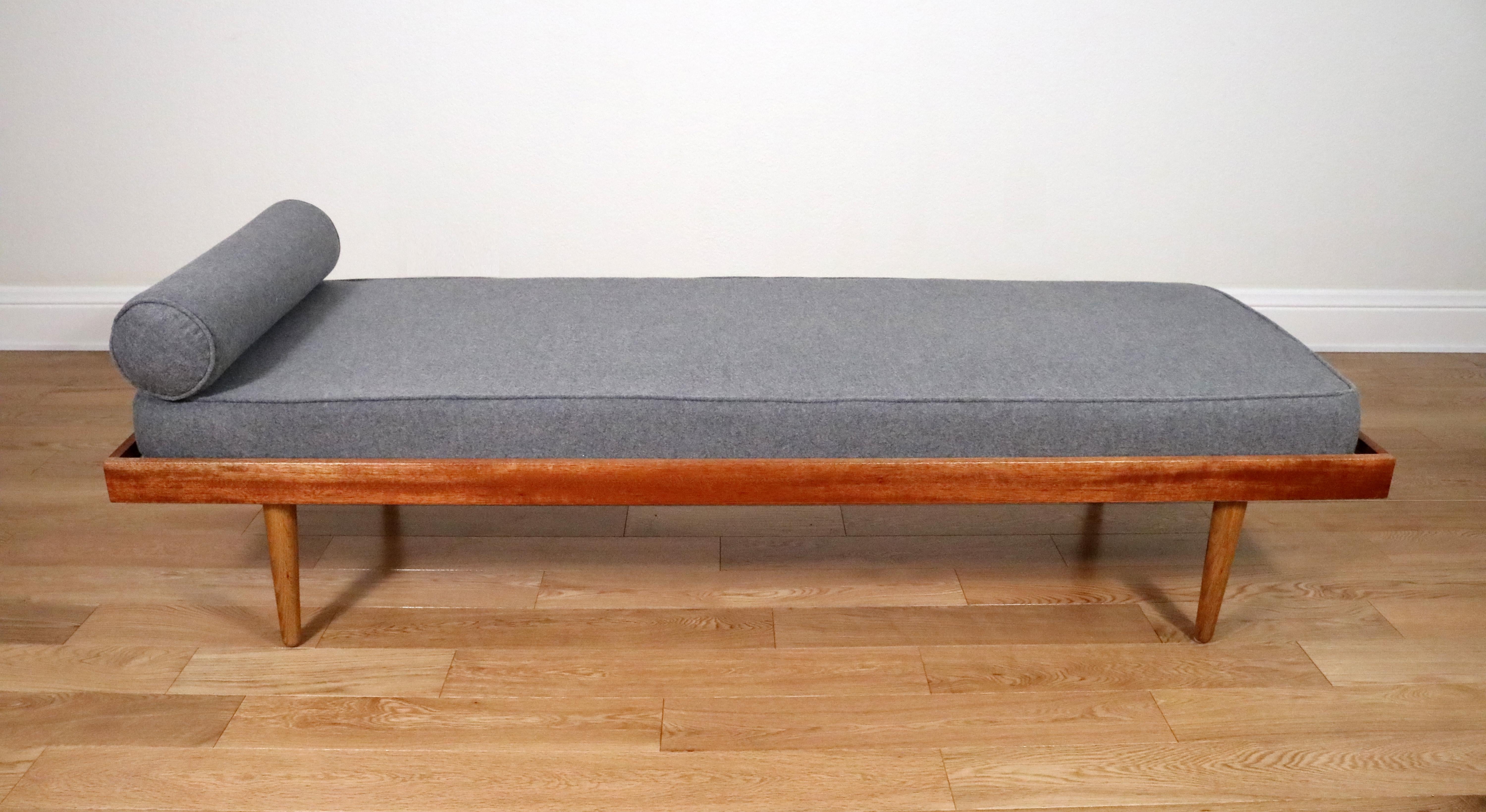 Handsome identical daybeds in grey wool on a white oak and African mahogany frame. 

Expertly crafted in Boulder, Colorado in the manner of Hans Wegner's GE-19 daybeds. 

Strong and sturdy frames support comfortable grey wool upholstered foam