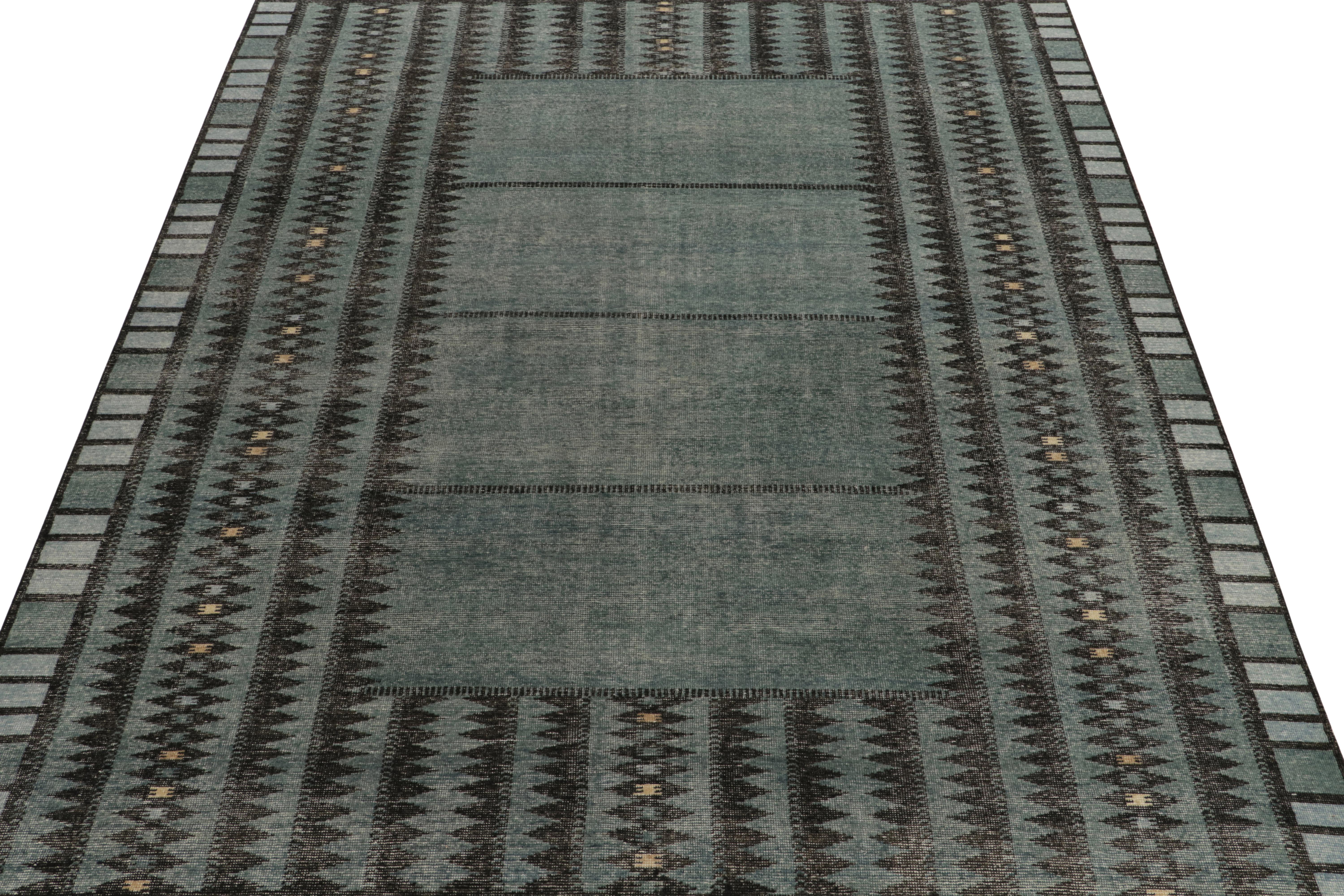 From Rug & Kilim’s Homage collection, a 9x12 handknotted rug donning a modern deco vibe. The vivacious scale witnesses stripes & geometric repetition in aegean blue, charcoal black juxtaposed by creamy beige & grey accents while exemplifying fine