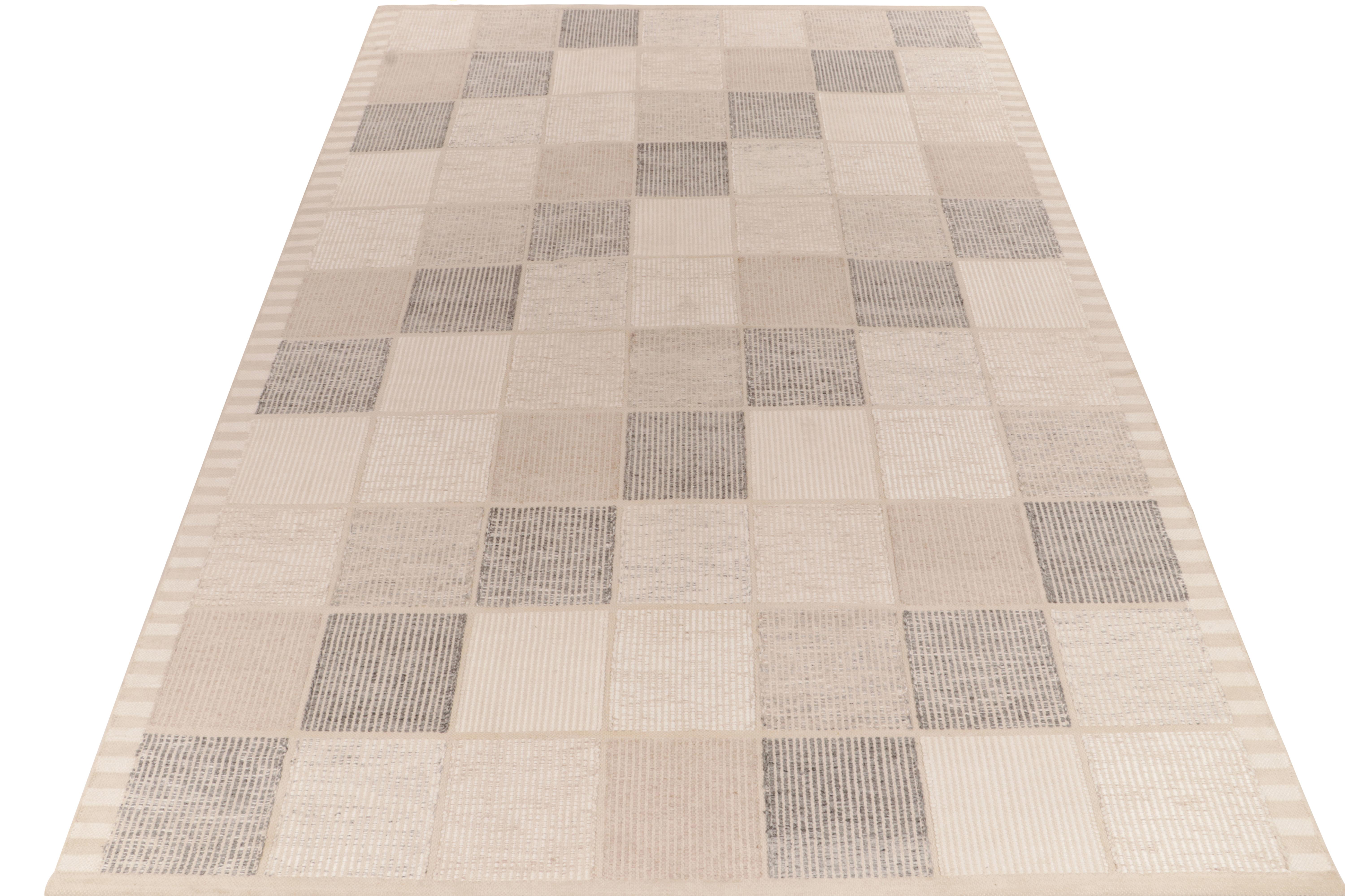 Exemplifying a modern take on Swedish Deco styles, a 10x14 flat weave from Rug & Kilim’s award-winning Scandinavian Kilim collection. The handwoven rug enjoys Moroccan design inspiration featuring compartmentalisation in white, beige, stone blue,