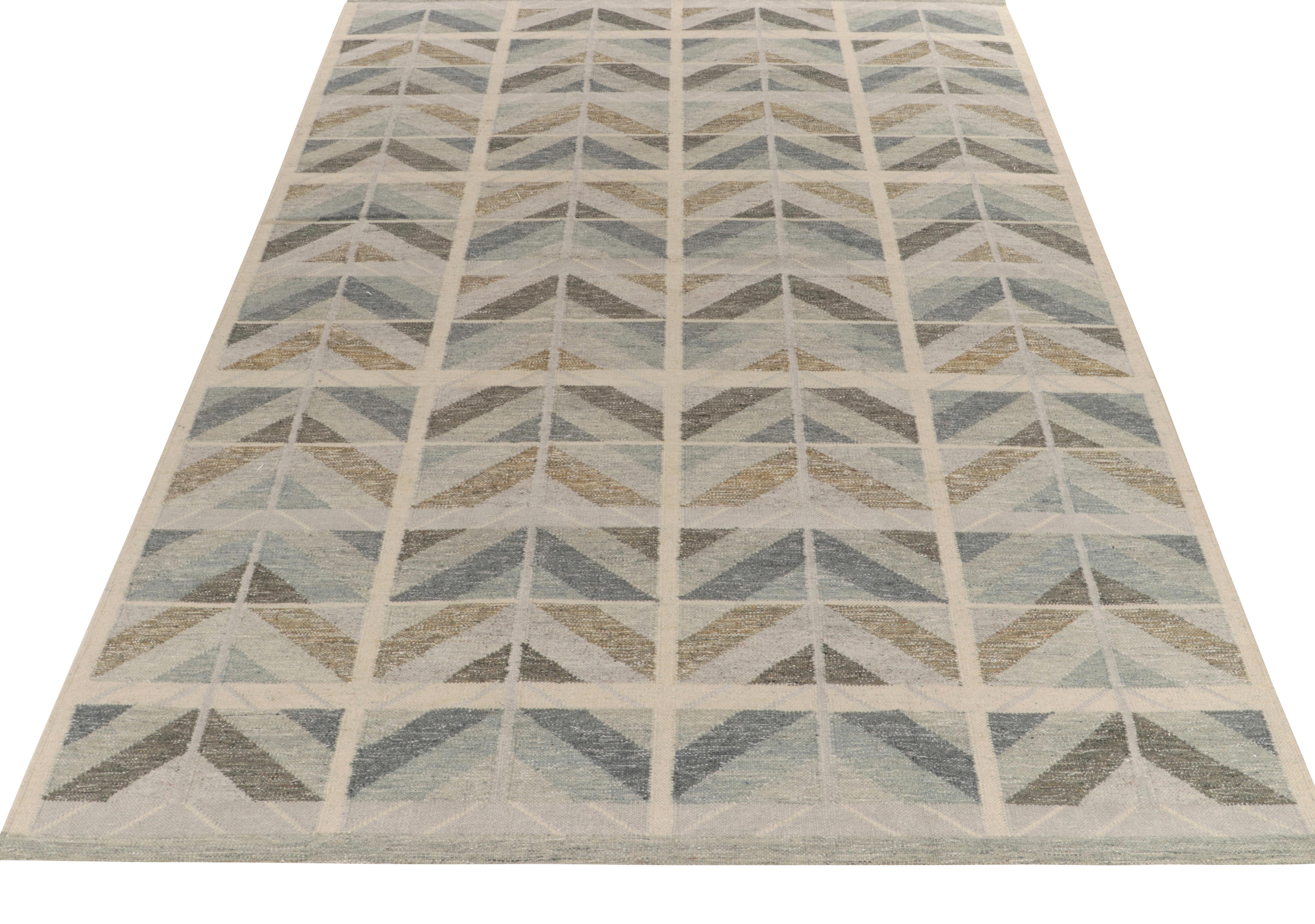 From our award-winning flatweave selections, a 10x14 Scandinavian style kilim rug showcasing unique movement & pleasing Mid-Century Modern symmetry. Handwoven in wool, the crisp chevrons embody the smartness lent by alternating tones of blue, brown