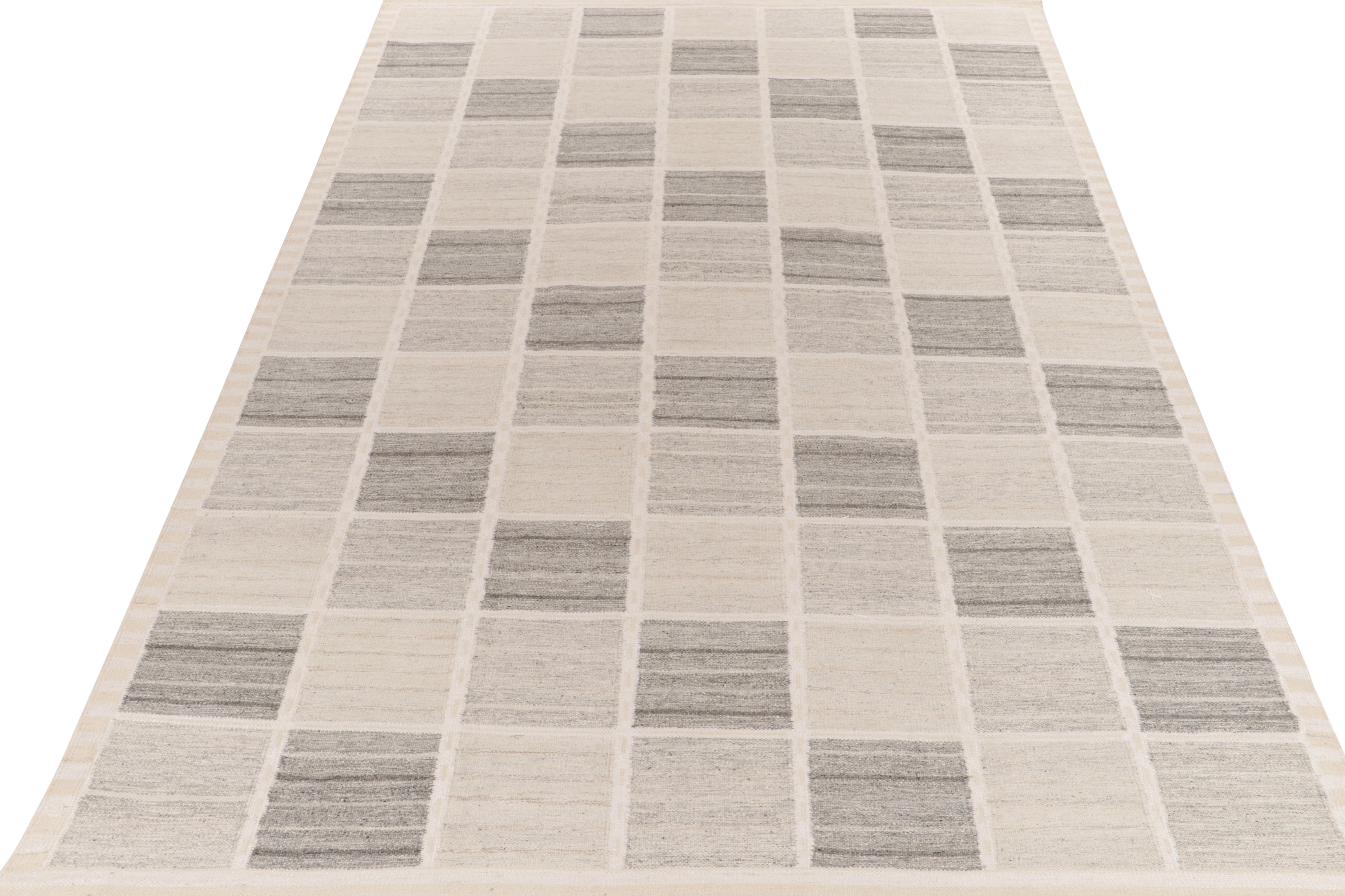 Exemplifying a modern take on Swedish Deco styles, a 10x14 flat weave from Rug & Kilim’s award-winning Scandinavian Kilim collection. The handwoven rug enjoys a smart application of geometry with well defined compartmentalisation entwining gray,