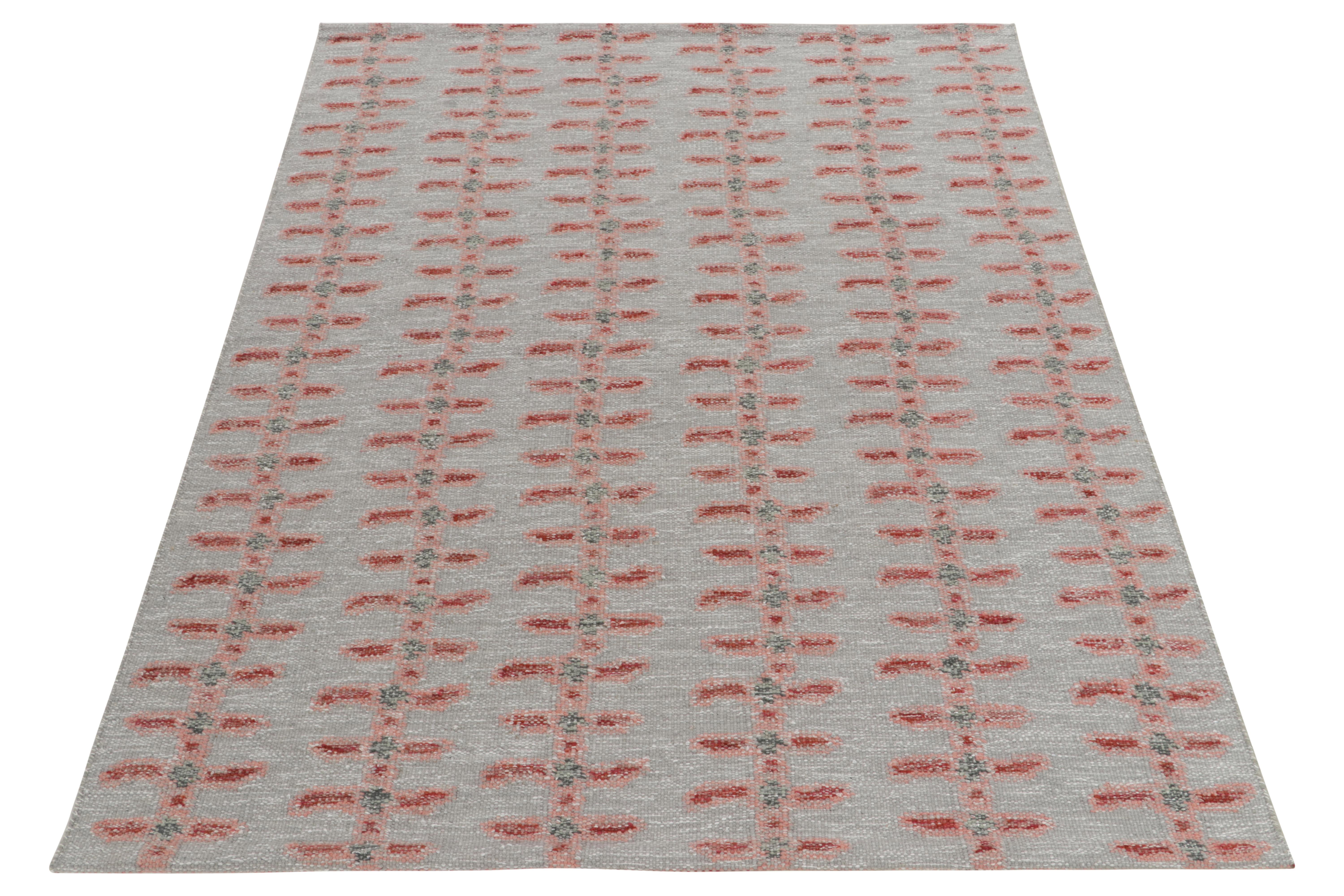 Handwoven in fine quality wool, a 6x8 kilim from our award-winning repertoire of Scandinavian flatweaves. The gray toned rug hosts geometric symmetry in bright red & soft pink for a delicious, depthful color play in such natural movement. Further