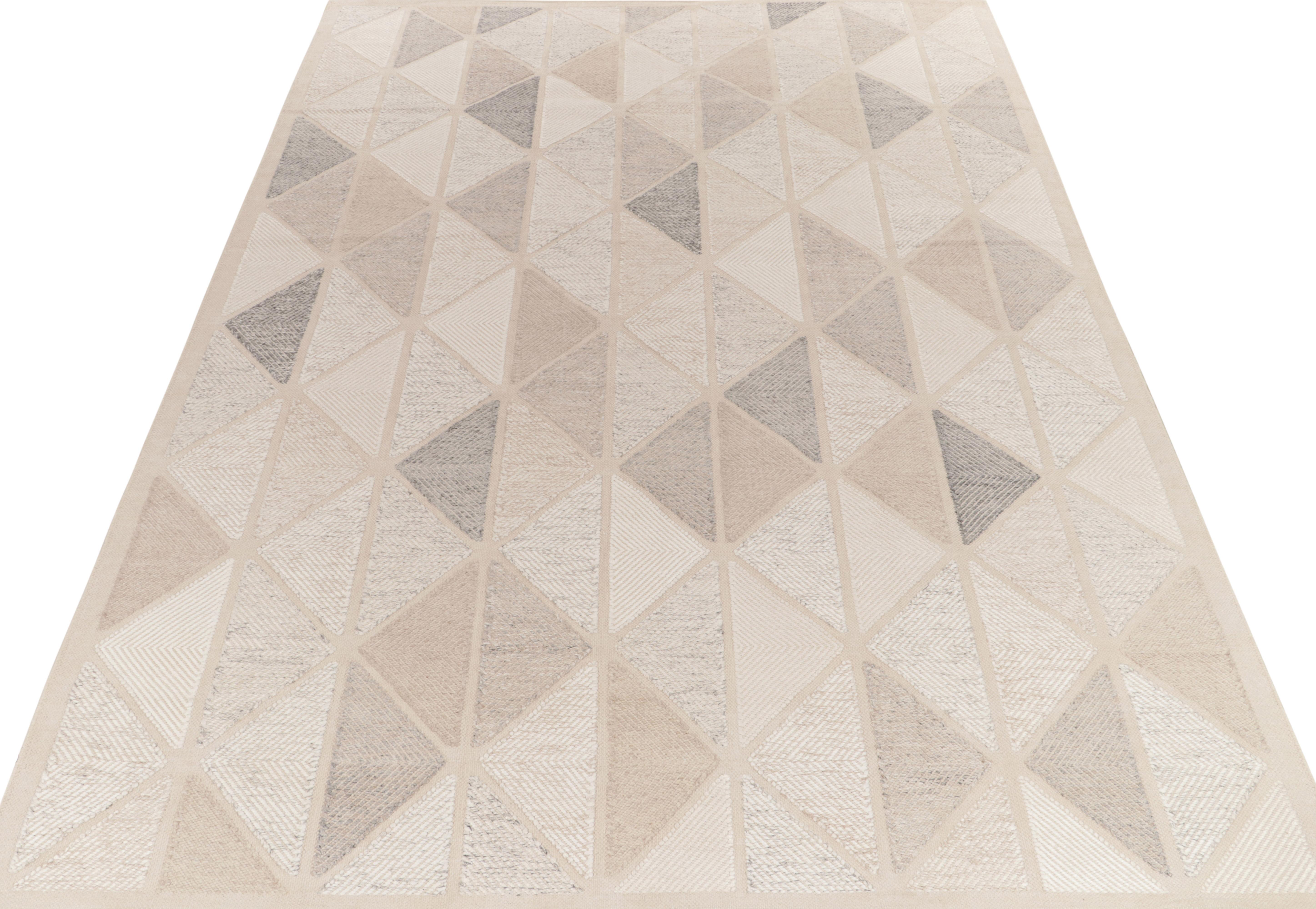 Rug & Kilim presents this exquisite 10x14 Scandinavian kilim from the Morocco line of the award-winning flat weave texture. The handwoven piece flows in an all over half diamond pattern in a delightful blend of beige, stone blue, gray & white. The