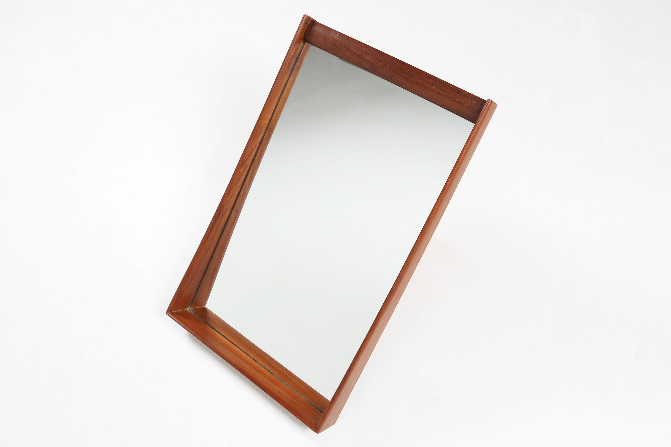 Scandinavian / 1960 / mirror / teak, mirror / Vintage / Mid-Century / Scandinavian Modern

A beautifully designed and constructed square wall mirror made in the 1960s. This mirror features a solid teak asymmetric construction with beautiful detailed