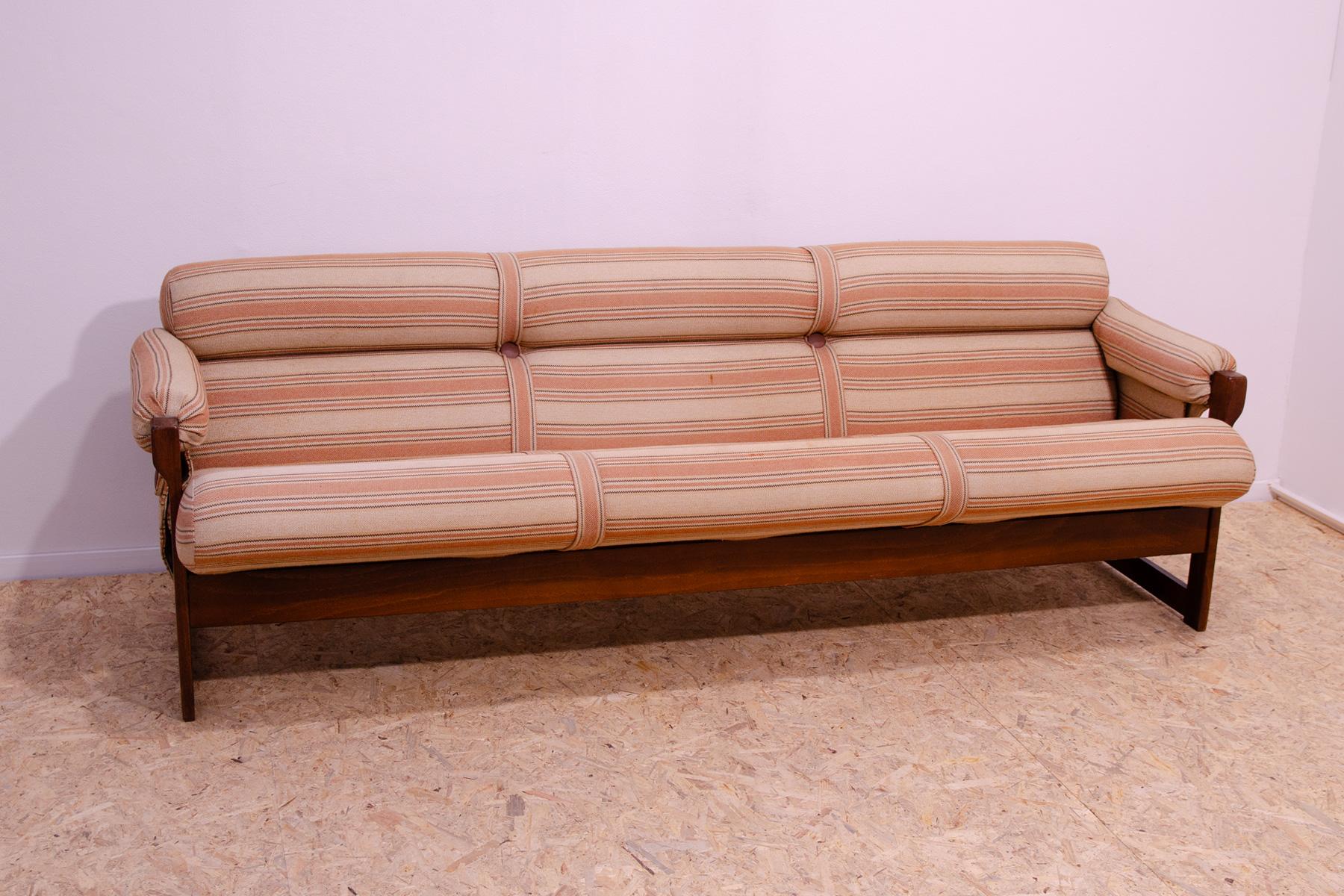 This lounge Scandinavian style three seater sofa was made by Hikor Písek company in the 1980´. It´s upholstered with fabric. The structure is made of beech wood. All in good Vintage condition, shows signs of age and use. In a few places, light