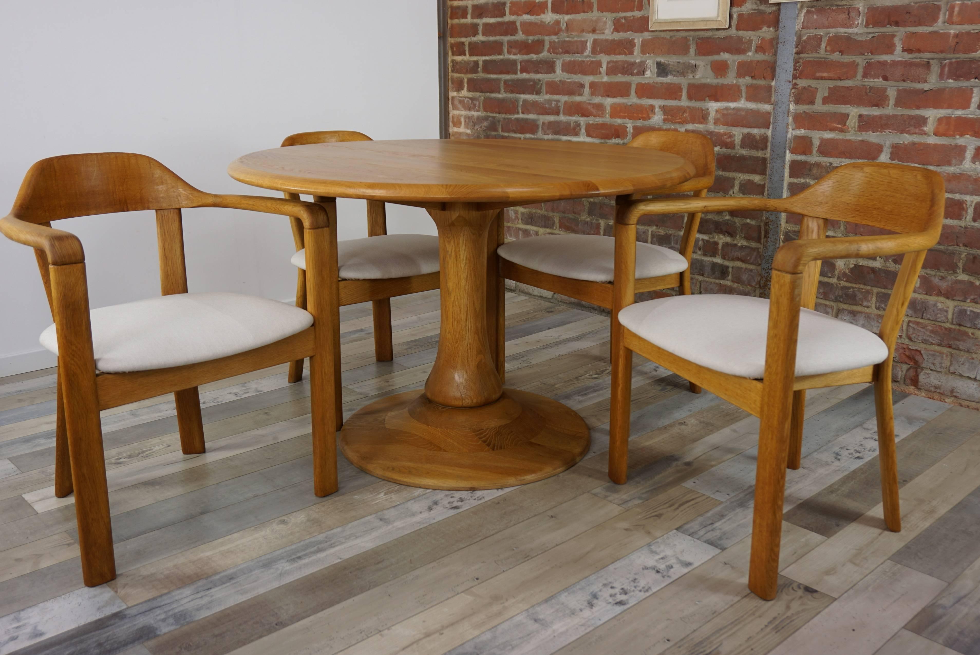 Solid oak dining set Scandinavian style composed of a round solid oak dining table (H 75cm / diam 115cm) with tulip shape foot (diam 70cm) and four matching dining armchairs (H77cm / H seat 47cm / W61cm / D55cm) in solid oak and fabric... All In