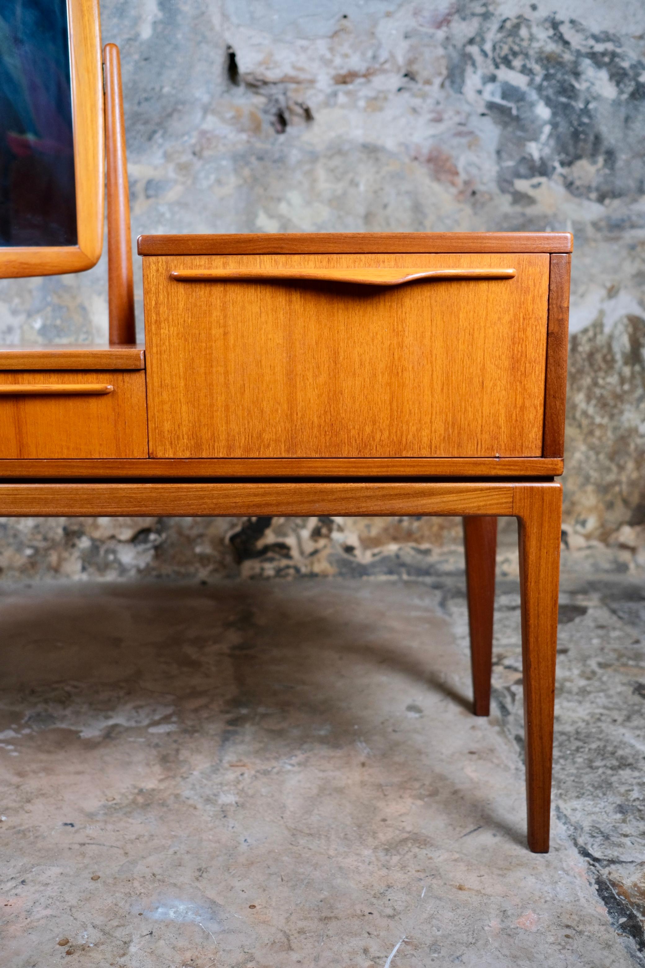 Elegant vanity table, Scandinavian style, crafted in France in the 1960s. 
Made of teak veneer, it features an adjustable mirror, a drawer, and a versatile storage compartment that opens from the top or the front.
In good overall condition with
