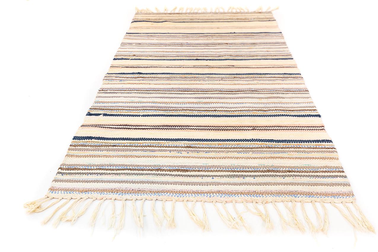 This  Scandinavian Swedish Kilim is a unique and special piece that seamlessly blends a range of colors with a neutral beige backdrop. This combination creates a versatile and visually appealing textile that can effortlessly complement various