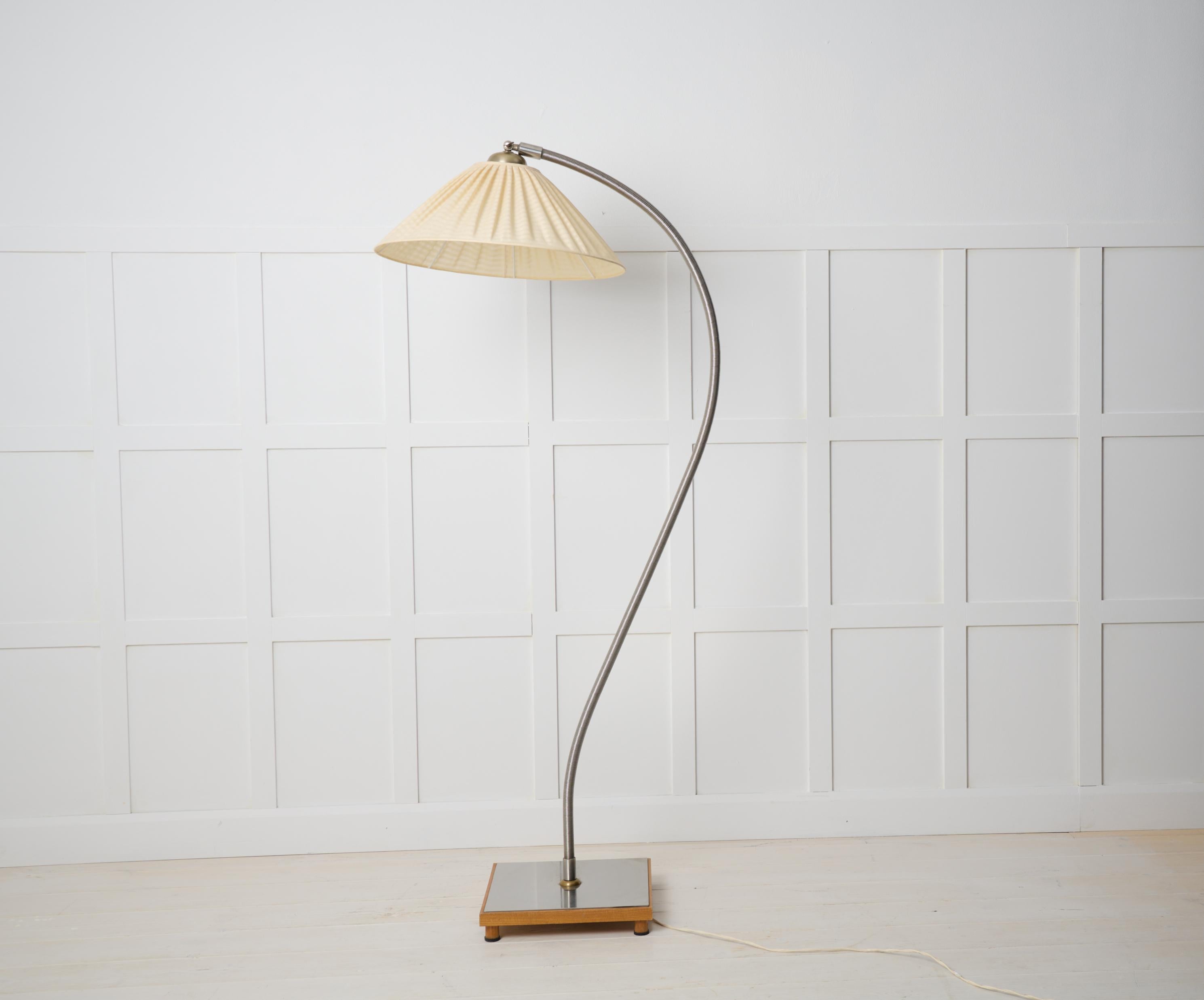 Swedish modern floor lamp in polished steel. The lamp is from around 1930 to 1940 and is made in Sweden. The lamp shade is original and the angle of it is adjustable. Original electrics according to Swedish standard which might need updating. The