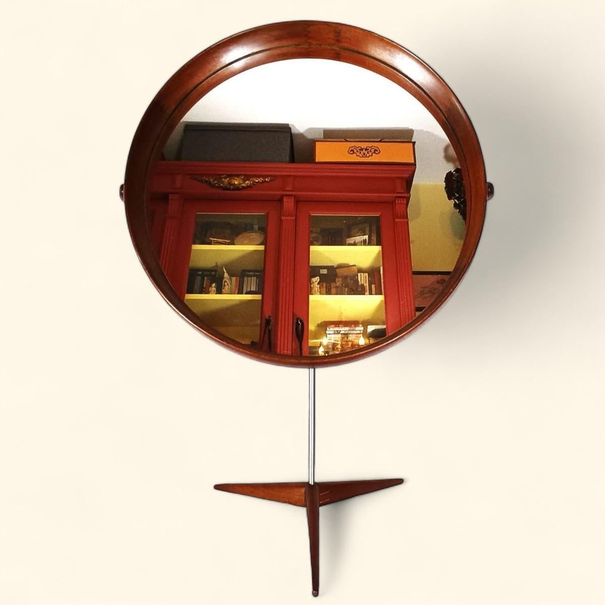 Rare and very elegant table or bathroom mirror by the Kristiansson brothers. 

The mirror frame is solid curved teak, typical of Luxus designs, with beautiful dovetail joints. It rests on a nickel-plated metal pen. on a teak and metal tripod base