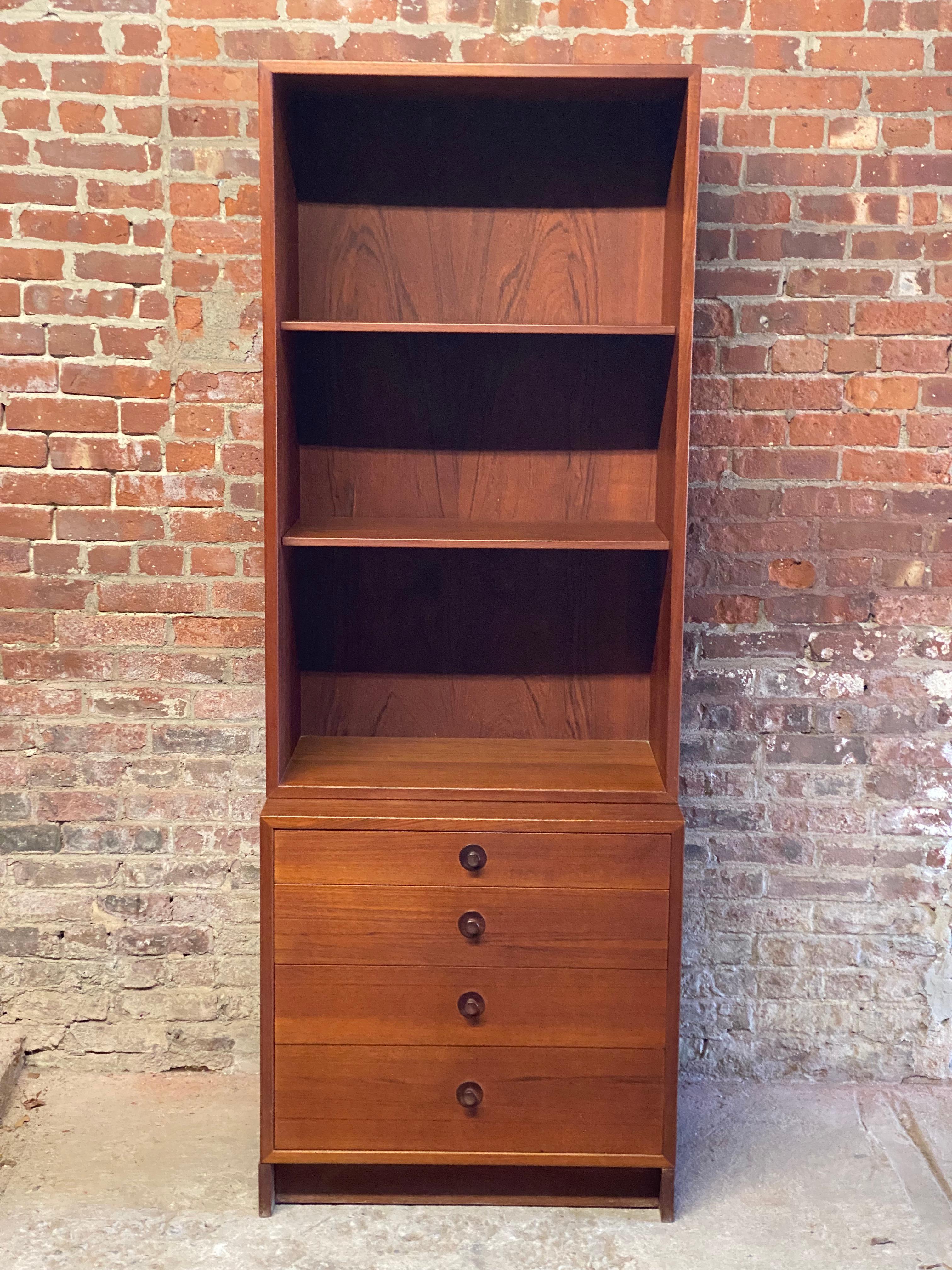 Teak Scandinavian design dresser/bookcase. Two adjustable shelves over a small four drawer cabinet. This piece has a small slim footprint that excels in any smaller apartment or living space. Refined and classic simple lines with solid darker cone