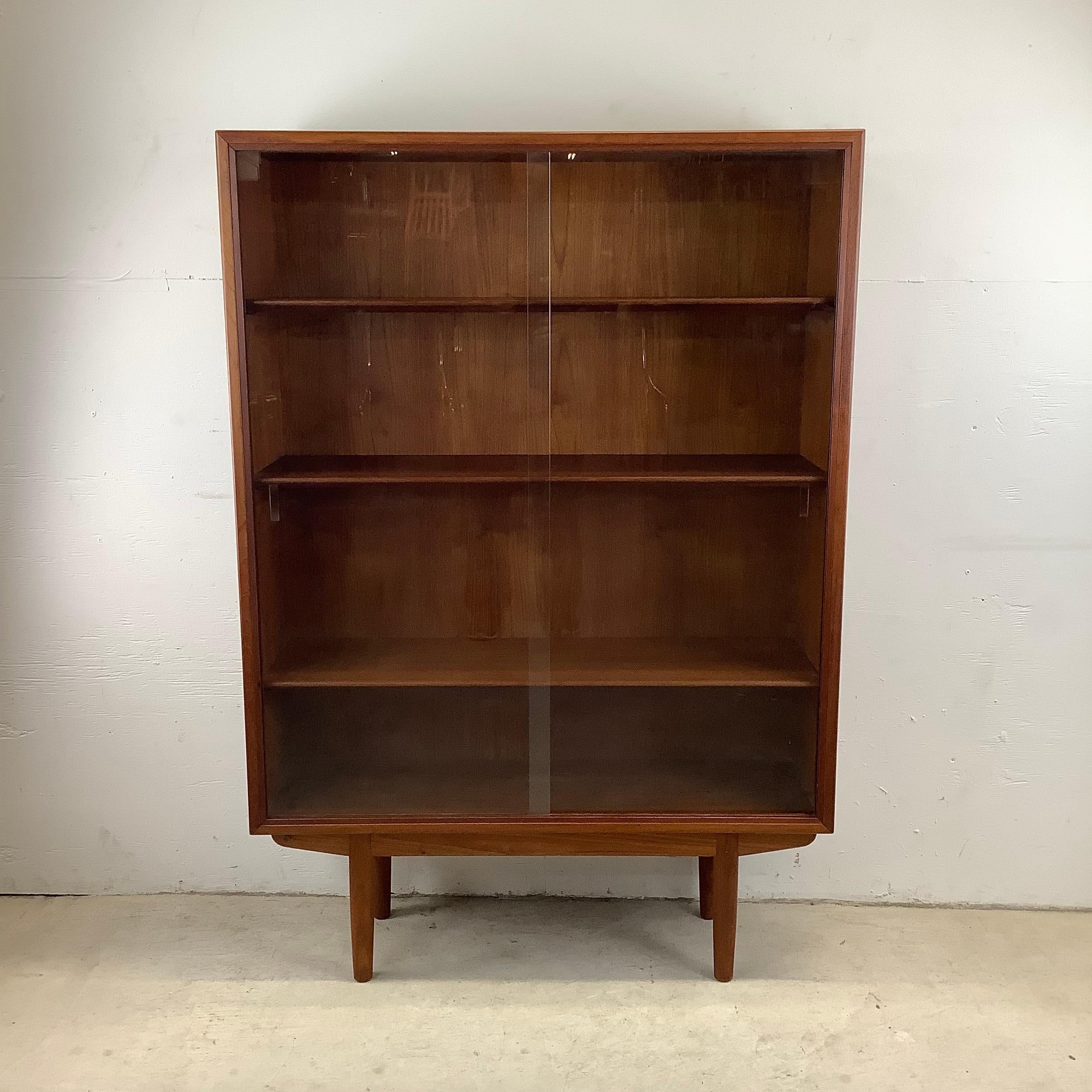Experience the timeless elegance of Scandinavian Modern design with this exquisite Danish Modern Bookcase, a true homage to Borge Mogensen's vision. Crafted in the 1960s by the esteemed Søborg Møbelfabrik, this teak masterpiece embodies the