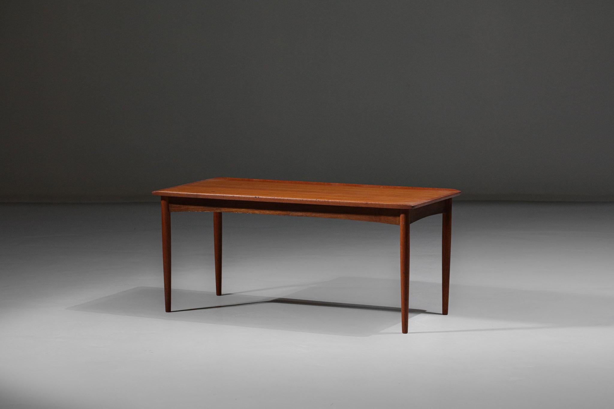 Danish coffee table from the 1970s. Solid teak or veneer structure, nice work of raised sides which gives an original look to this typical Scandinavian design table.