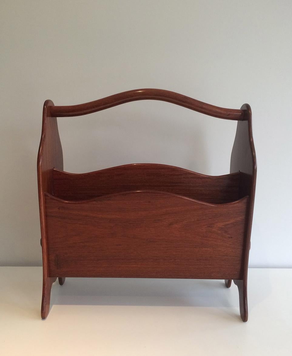 This magazine rack is made of exotic teak. This is a French work, circa 1970.