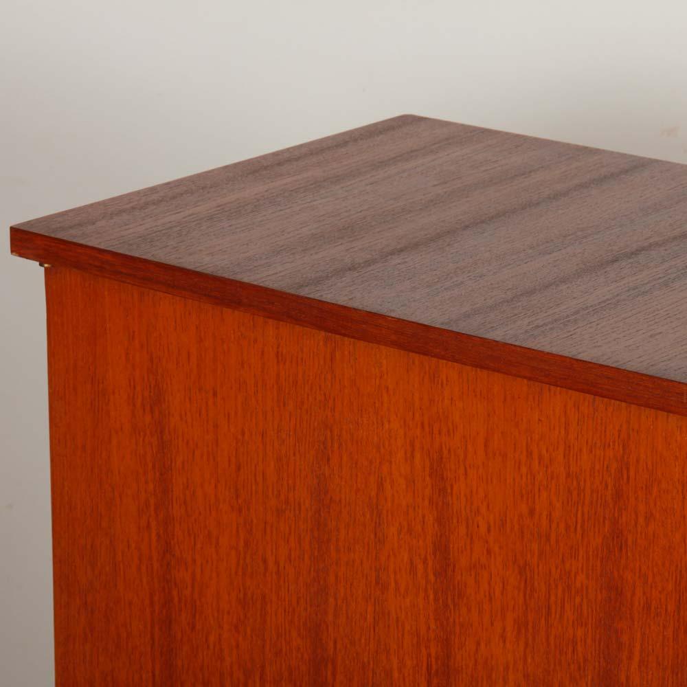 This vintage Scandinavian teak cabinet dates from the 1960s. It features plenty of storage space and opens in the center with glass doors. The cabinet is in good original condition. The top has been restored. 