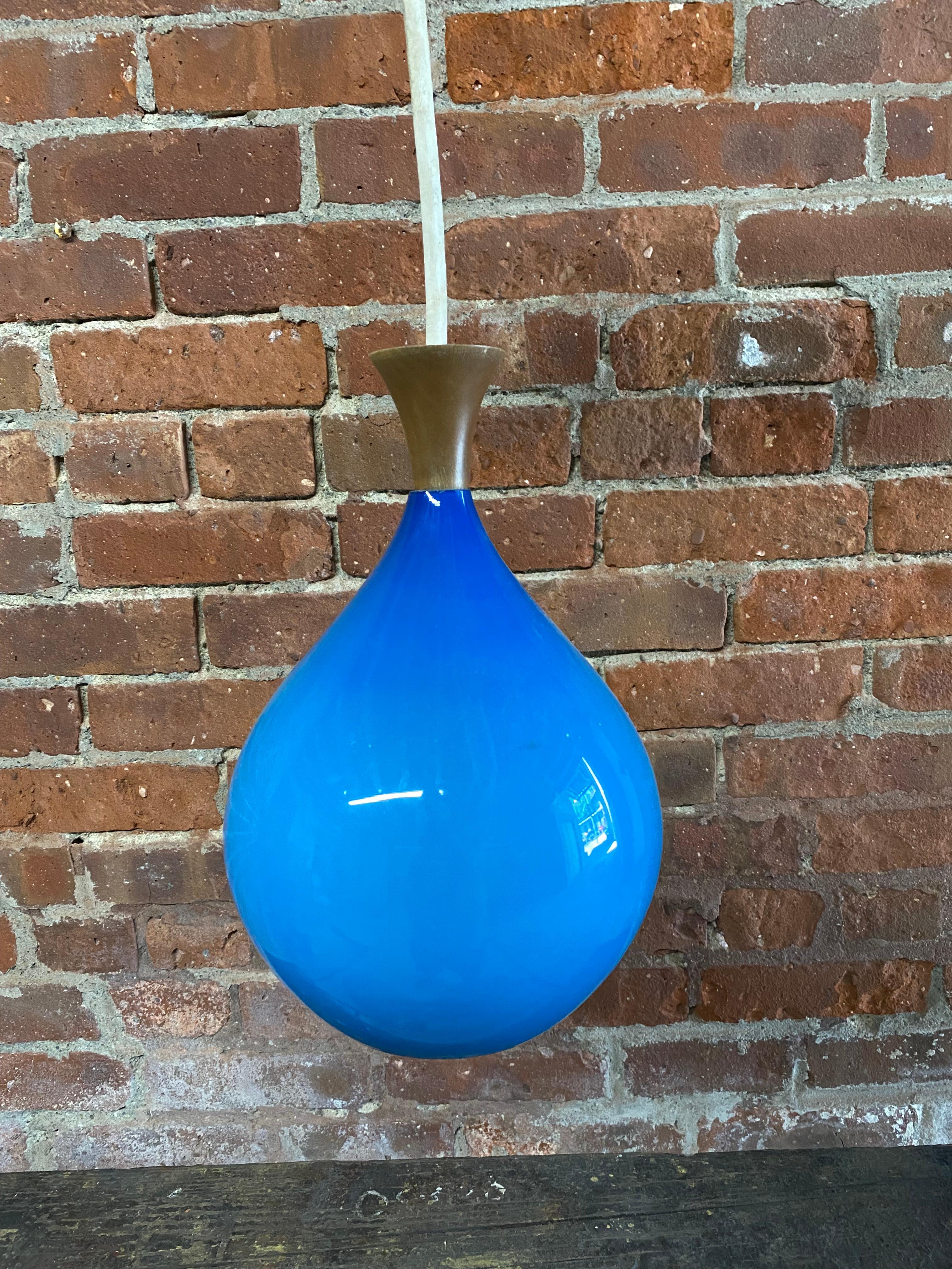 Sky blue and white cased glass hanging light fixture with wood finial. The bulb socket bares the Halcolite label. Circa 1960. Halcolite was a New York City importer of fine glass lighting amongst other lighting choices in the 1950s -70s. Good