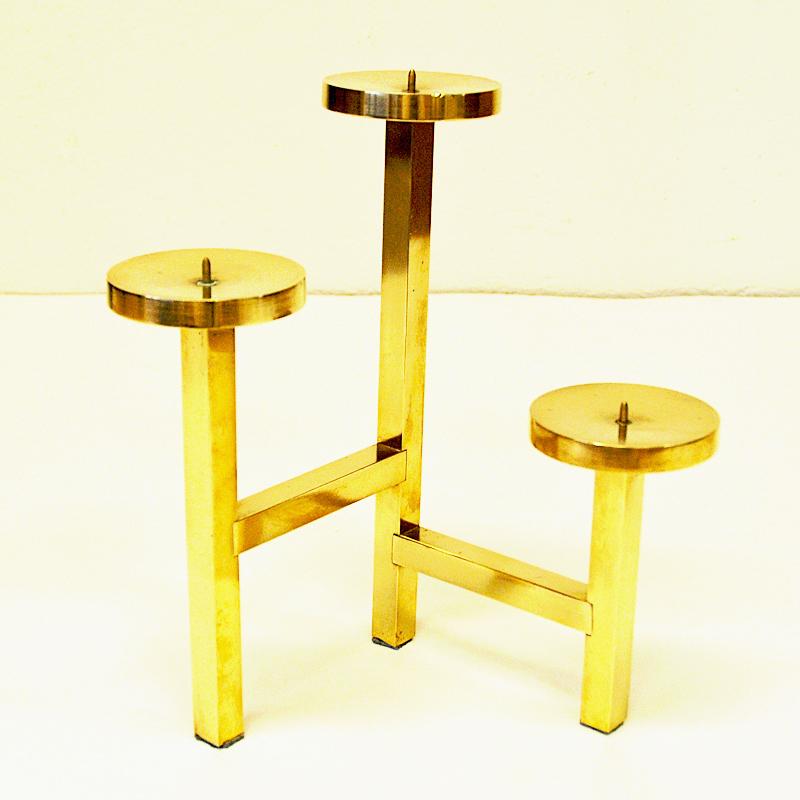 Vintage decorative brass candleholder for three cube candles from the 1970s. The candleholder has three height levels and are designed as a triangle. Measures: 24.5 cm H. 19 x 23 cm L. Height. Scandinavian design. Good vintage condition.