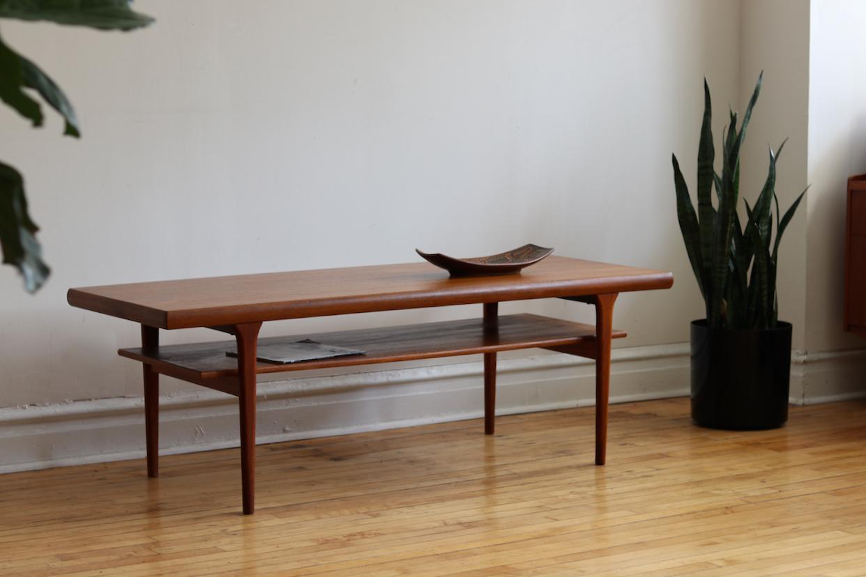 Danish Mid-Century Modern two-tier coffee table.
Just imported from Denmark!
Refinished teak.
Minimal and sleek lines.
Tapered legs.
Excellent vintage condition.
Measures: 63