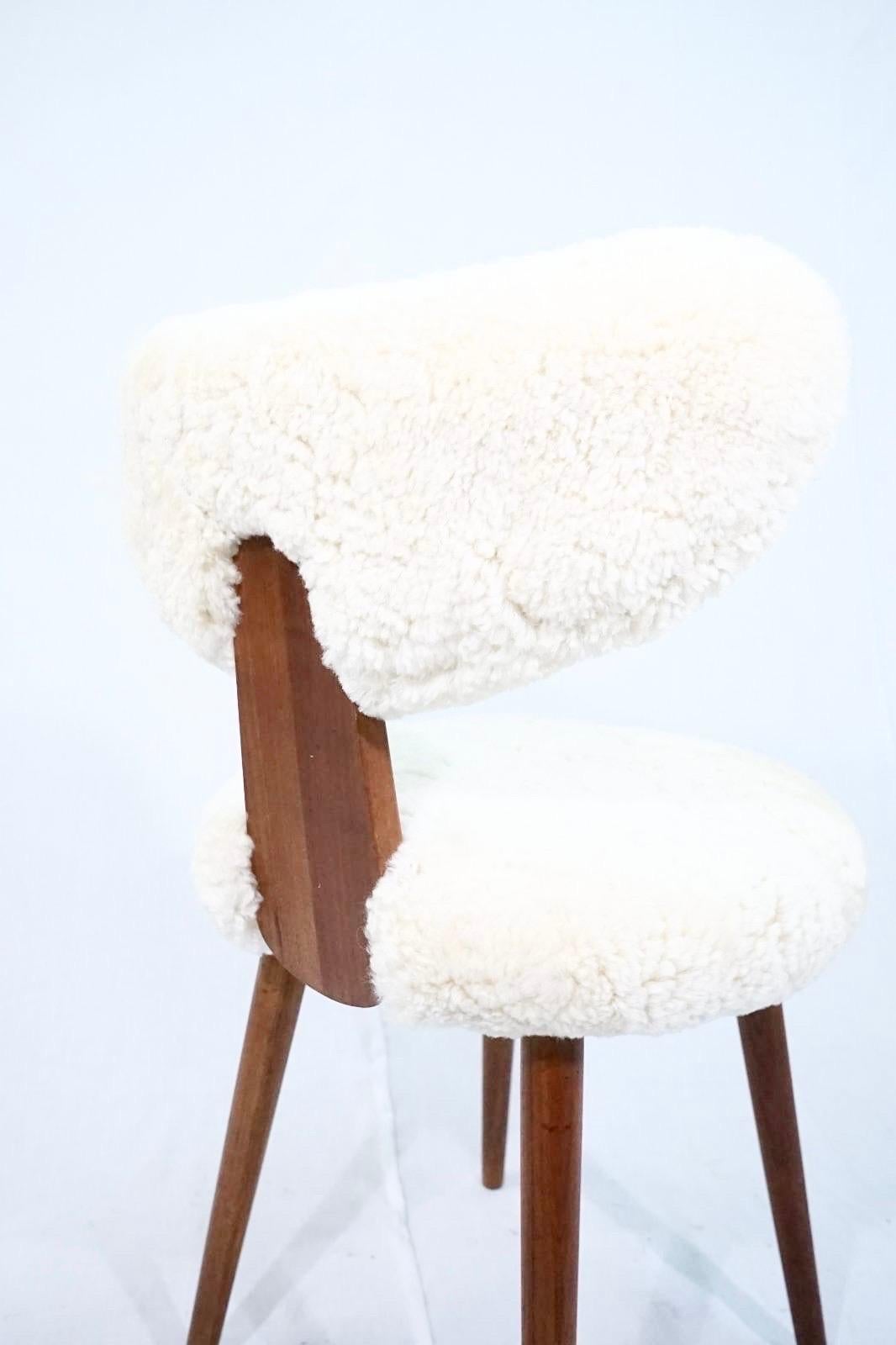 Rare Scandinavian vanity table chair in solid teak with lambs wool in the manner of Magnus Stephensen.
The chair is newly restored and has been reupholstered in shearling lambs wool by a professional danish upholster.
The chairs backrest is